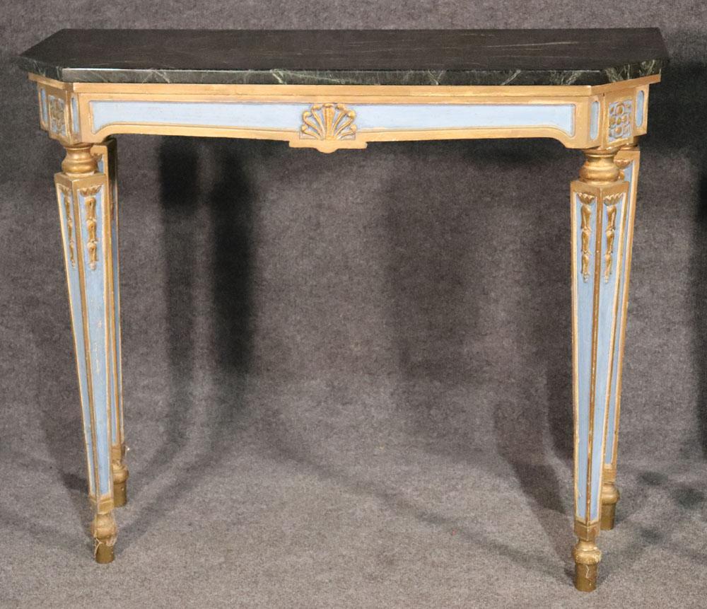 This is a rare and superb pair of fine Russian console tables with gilded trim and anthemia, circa 1920. The tables are in very good condition with no damage to the marble tops or royal blue and gold gilded frames. These tables are exceptional in
