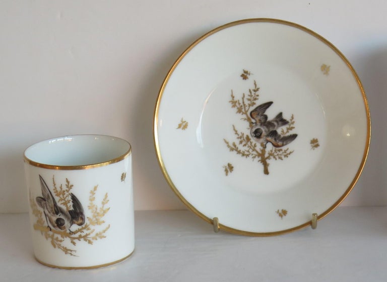 This is a very beautiful porcelain coffee can made by a French Paris maker, dating to the very early 19th century, circa 1800.

The very fine Paris Porcelain coffee can is carefully hand painted with a bird on a gilded branch, with further hand gold