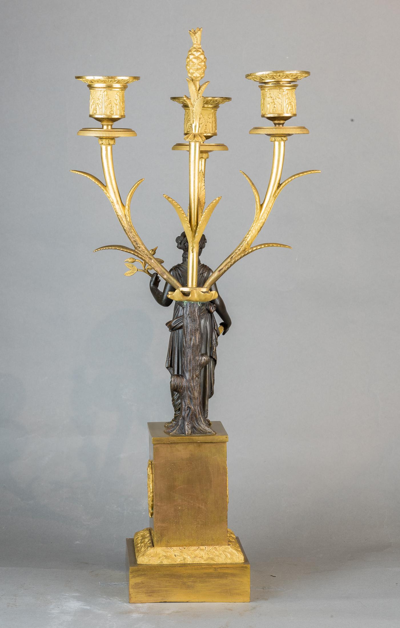 Fine Patinated and Gilt Bronze Three-Light Figural Candelabras In Good Condition For Sale In New York, NY