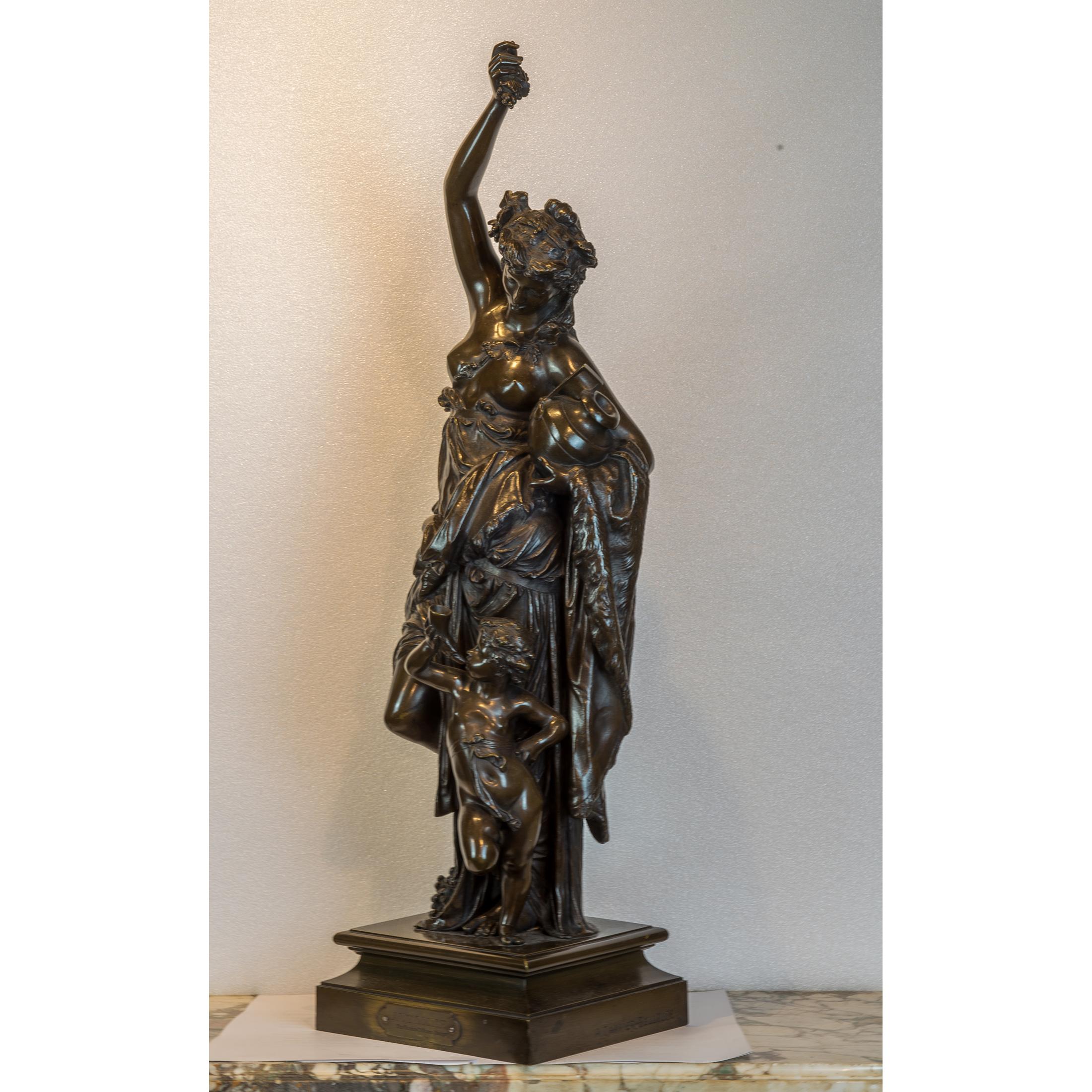 Modeled as a bacchanalian maiden holding aloft a bunch of grapes and a jug in the other, accompanied by a putto holding a horn cup, on square base, incised A. CARRIER-BELLEUSE, with applied title plaque to front.

Maker: Albert Carrier-Belleuse