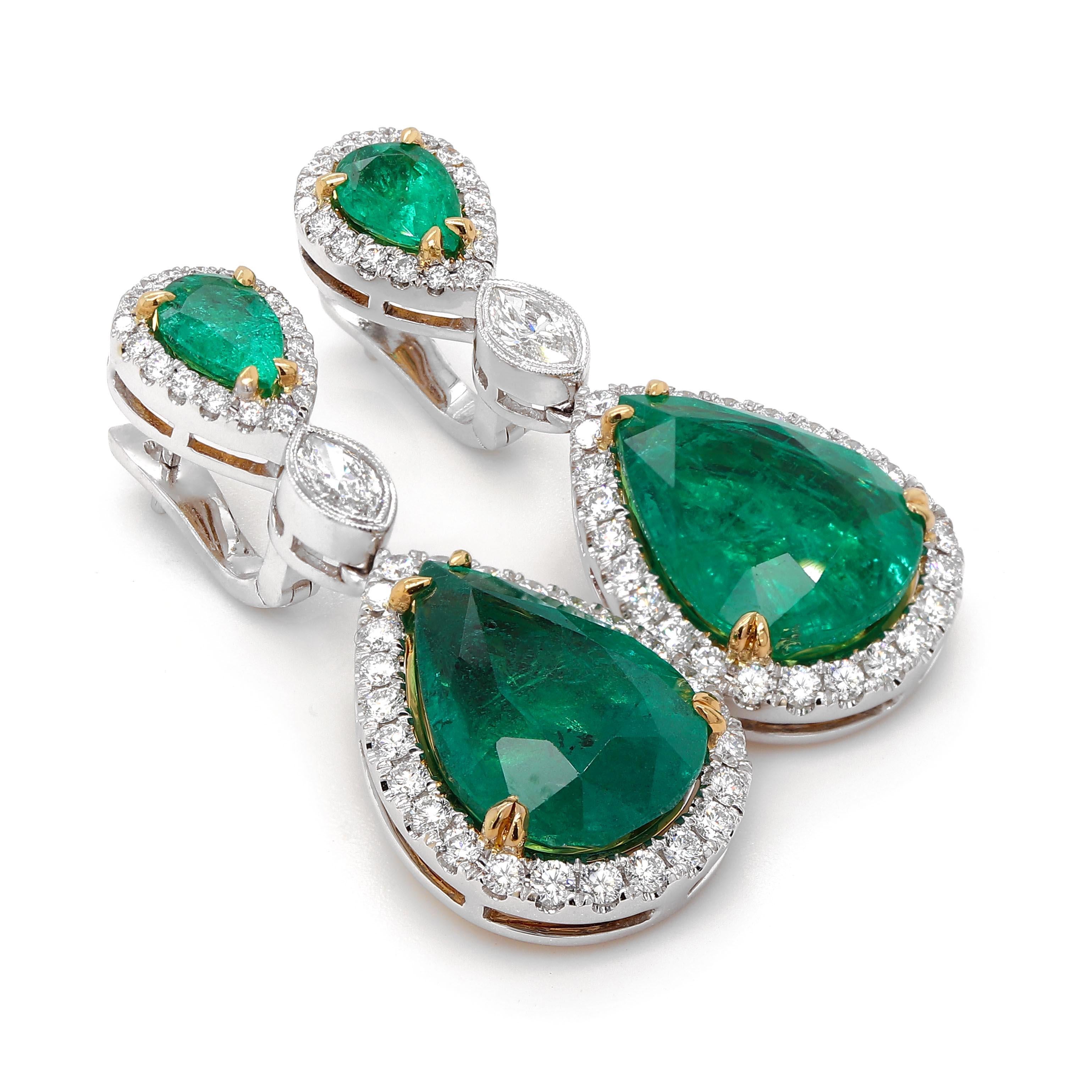 Earrings containing 2 pear shape Emeralds of about 11.91 carats and 2 pear shape Emeralds of about 1.31 carats. It also contains 2 marquise shape diamonds of about 0.40 carats. The emeralds are surrounded by 86 round brilliant cut diamonds of about