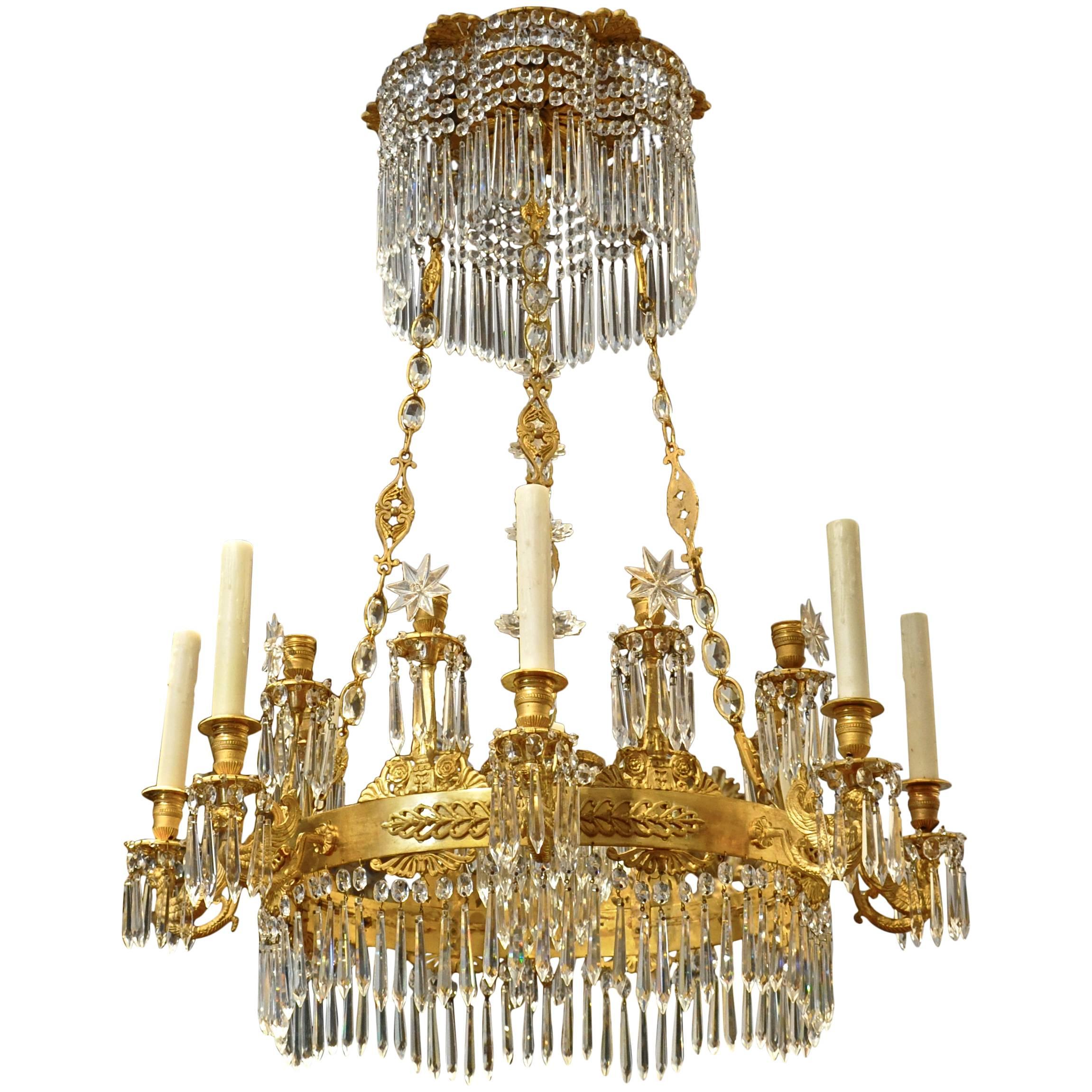 Period Russian Empire chandelier.

Eight-winged lion candle arms.
Palmettes and torches.
Original crystals intact.
Beautiful acanthus crown.

This amazing chandelier is shown without and with a cobalt blue glass plate as options

Was French