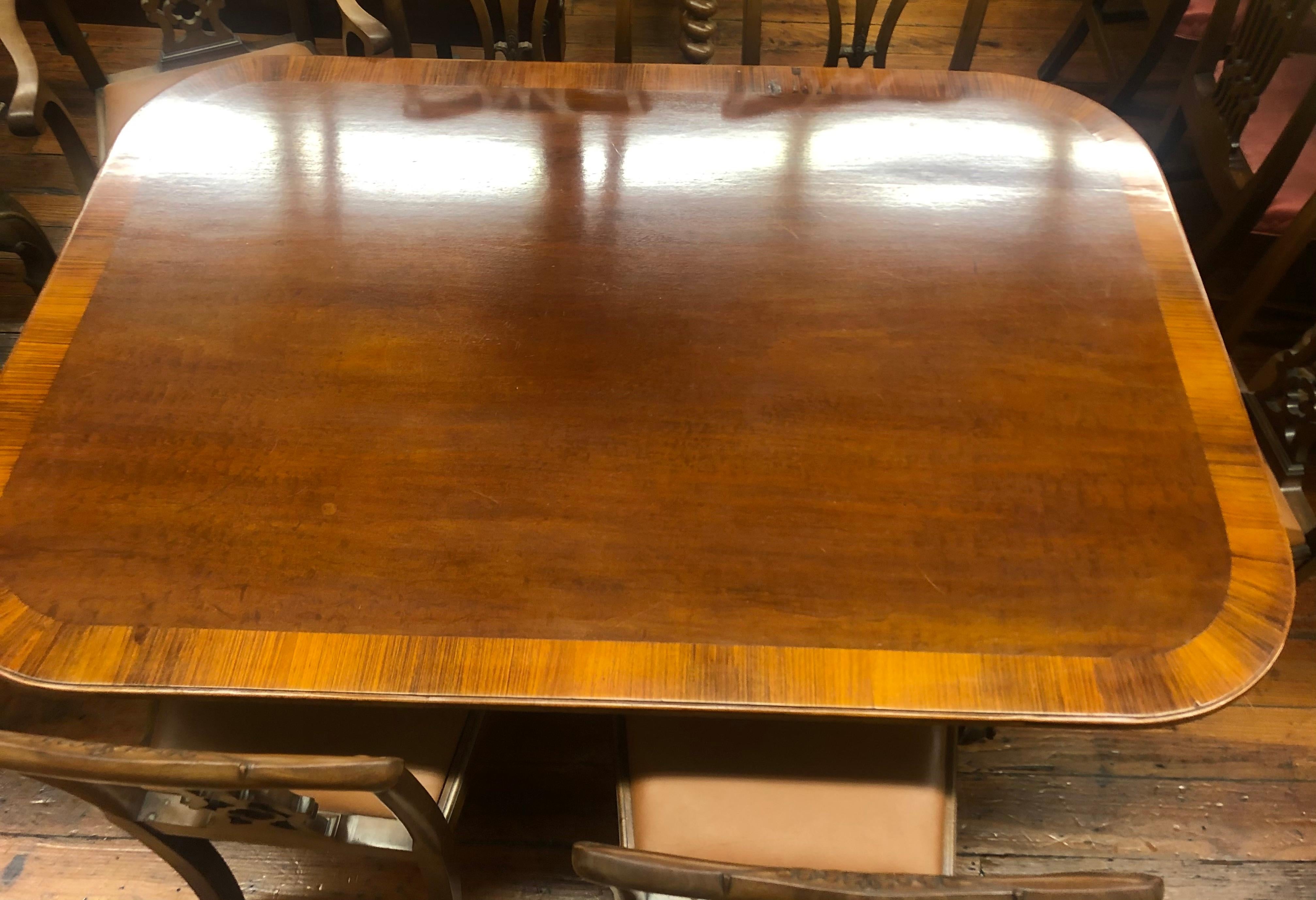 Fine and rare antique English period Geo. III Sheraton style tilt top rectangular dining table, with a wide satinwood inlaid crossband around the perimeter of the table. Quad leg reeded pedestal, tilt-top. Old repair to an area mon the satinwood