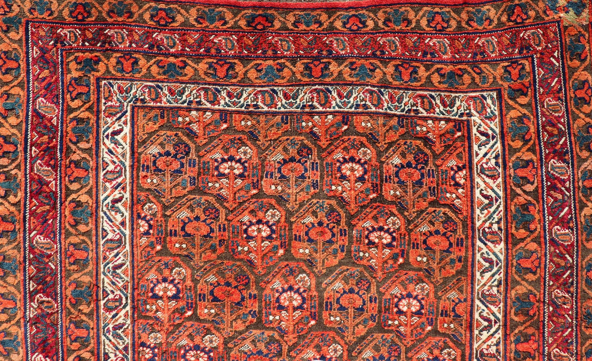 Noué à la main  Tapis persan ancien Afshar à fond orange et cuivre et multicolore en vente