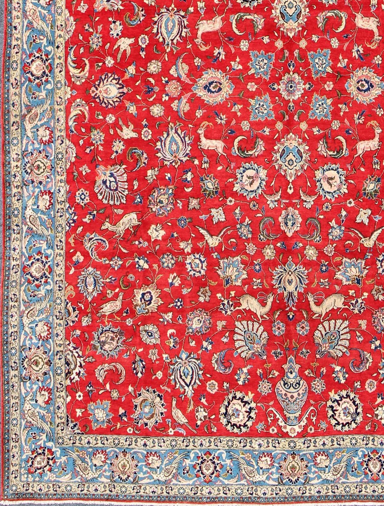 Vintage fine Persian Isfahan rug with all-over floral design, red background and Blue Border, rug h-404-05, country of origin / type: Iran / Isfahan, circa 1950.

This outstanding midcentury Persian Isfahan carpet is primarily characterized by its