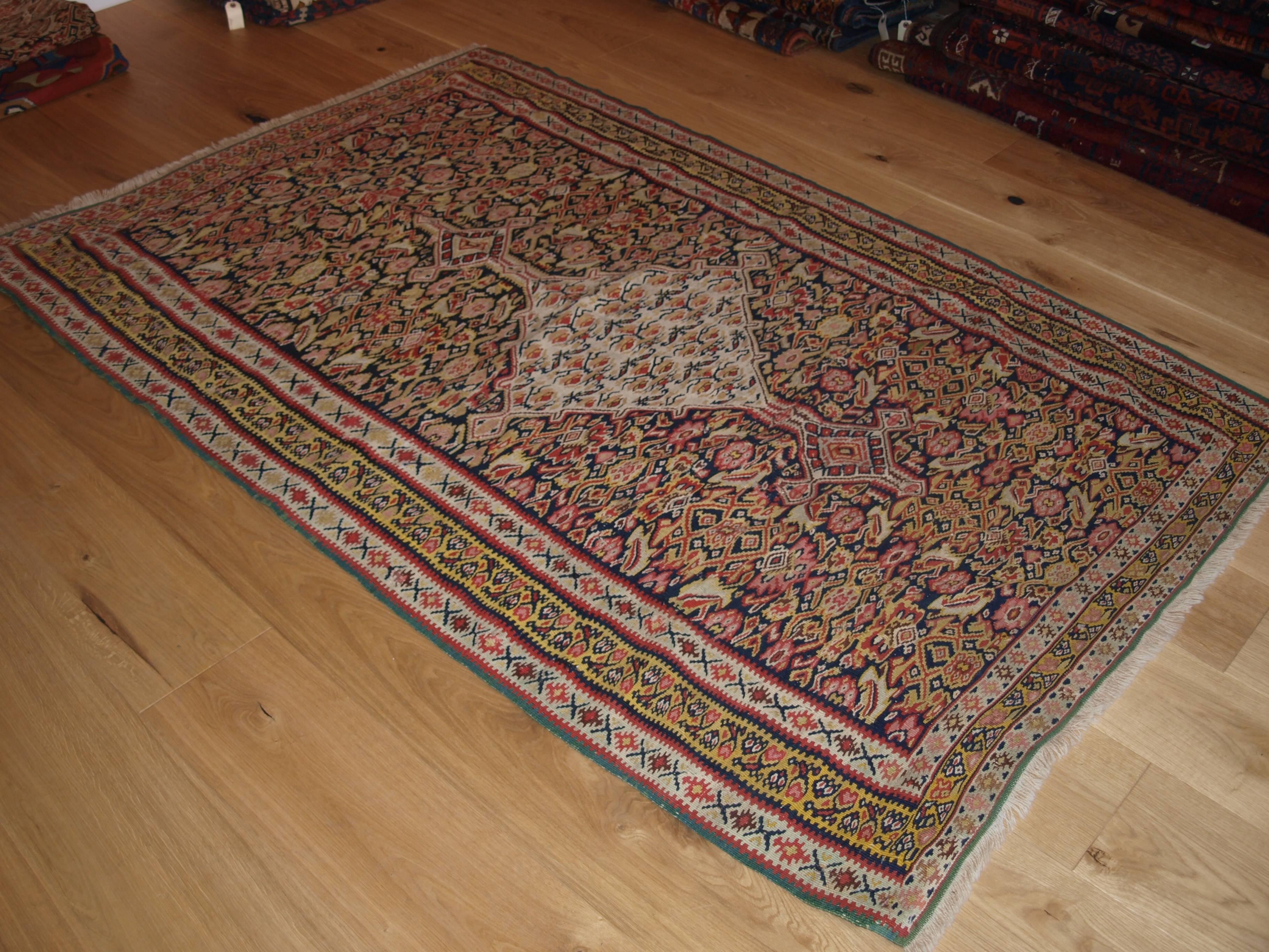 Size: 6ft 5in x 3ft 11in (196 x 120cm).
A fine Persian Senneh Kilim with soft colors and a traditional medallion design,
circa 1900.
This is a good Senneh Kilim with the overall design being the Classic Heratti design which is found in most