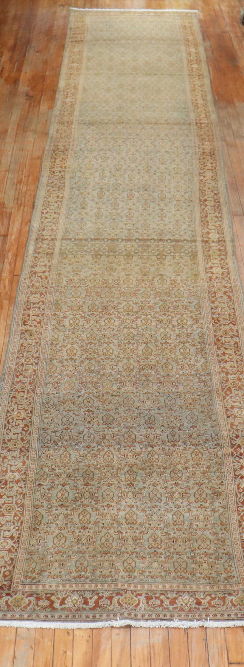 Fine quality brownish blueish/green/gray field, terracotta border Persian Senneh Runner. It has that repetitive Classic Herati design you see in most senneh rugs. The colors are dreamy, circa 1910.

Size: 3'6