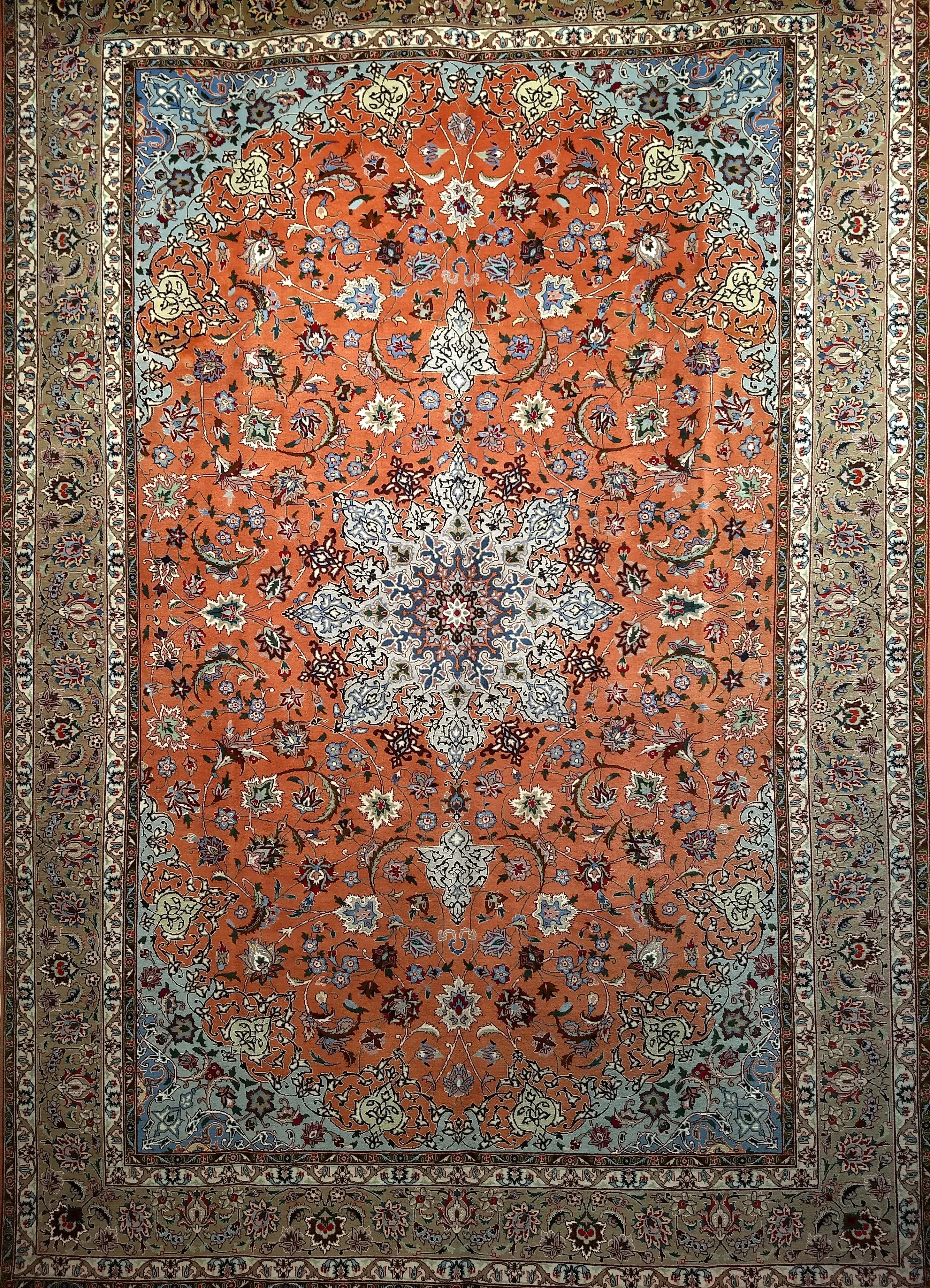 A fine Tabriz floral pattern room size rug in a rust-red field color and light brown or caramel border. The rug was woven in the 4th quarter of the 1900s but has never been used so it is considered “new”.   It was hand woven in one of the finest