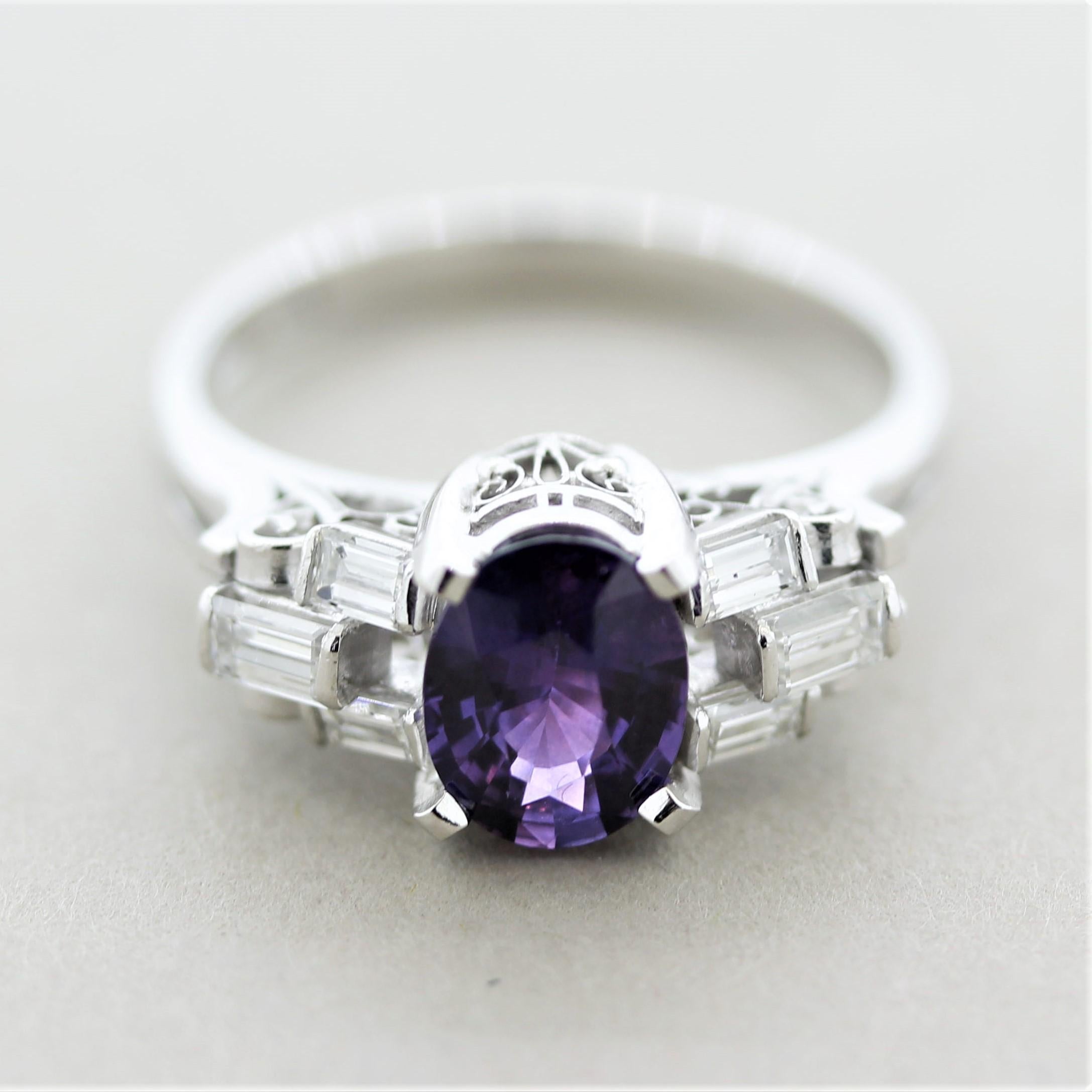 A gem of a sapphire takes center stage of this diamond platinum ring. The sapphire weighs 1.36 carats and has a stunning bright and vibrant purple color rare to find in sapphire. It is accented by 0.45 carats of baguette-cut diamonds set on the