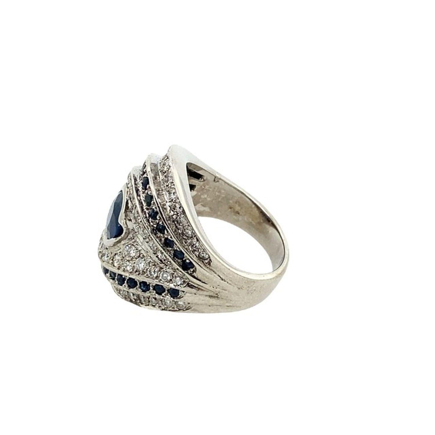18ct White Gold Fine Quality 0.75ct Oval Sapphire Ring Surrounded by Diamonds

Additional Information:
Total Diamond Weight: 1.0ct
 Diamond Colour: F/G
 Diamond Clarity: VS2
Total Sapphire Weight: 1.25ct (0.75ct Oval + 0.50ct Small Round)
Total