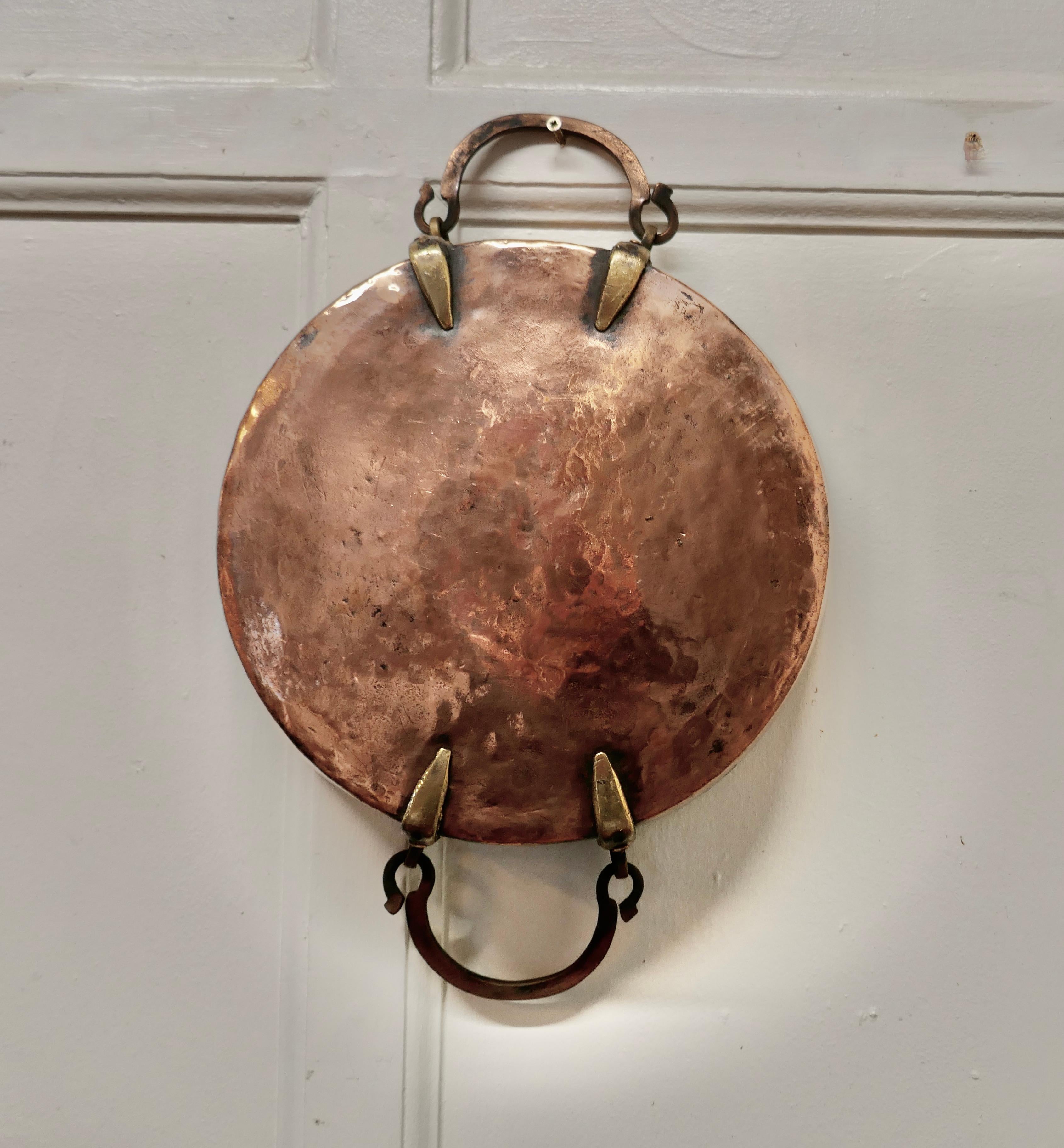 Fine Quality 19th Century Copper Roasting Pan 

This is a lovely looking 2 Handles Pan, the pan was obviously a very treasured piece, it has brass riveted handles and high sides 
The Pan is in good condition, it has a tinned interior, a much
