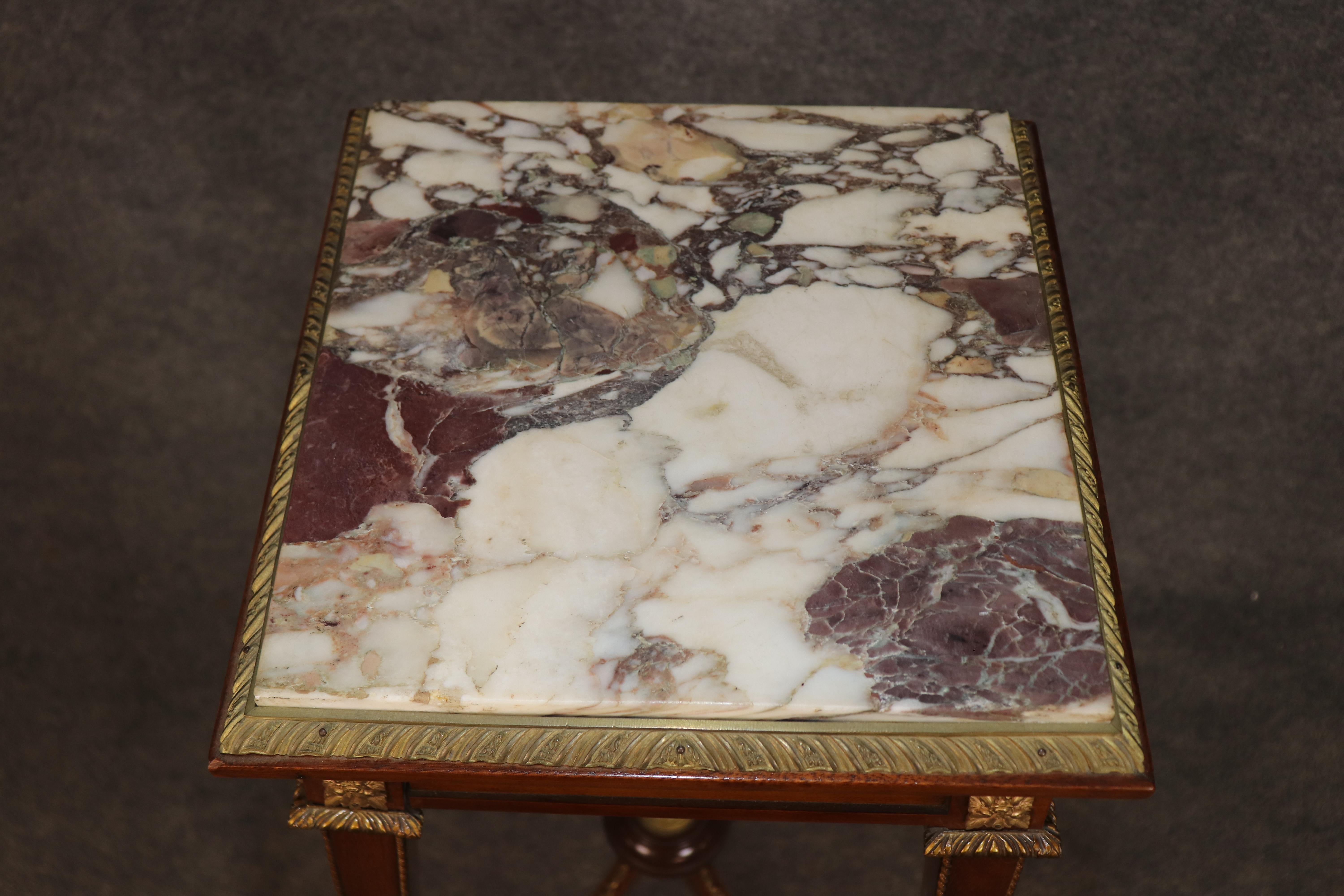 This elegant antique walnut and bronze pedestal with a marble top is a refined 19th-century piece designed for displaying plants, sculpture, or decorative objects. The stand features a square top fitted with richly veined marble, framed by a finely