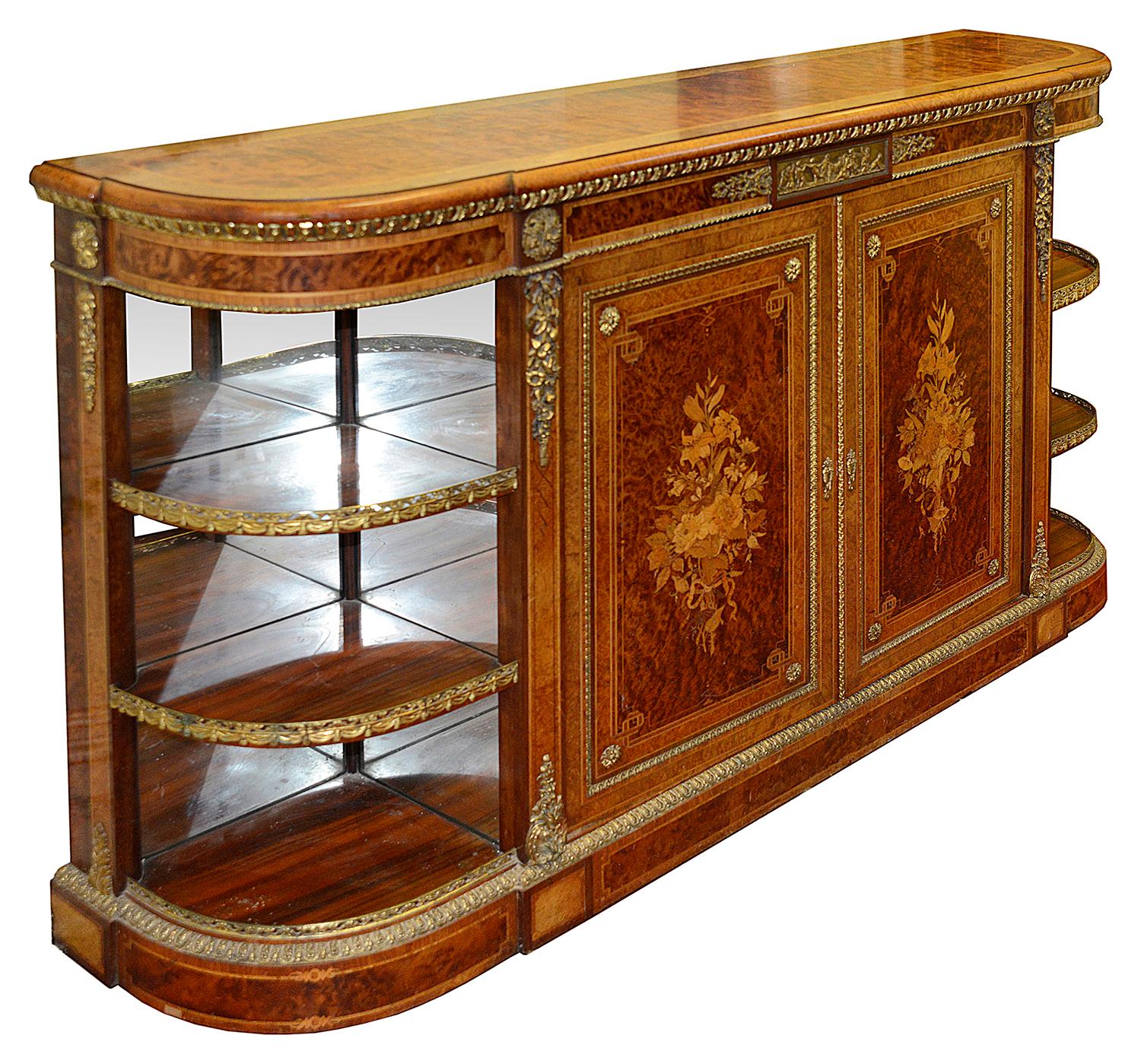 A fine quality 19th century mahogany, amboyna veneered credenza / side cabinet, having wonderful gilded ormolu mounts and a plaque to the frieze depicting children playing a game of tug of war with a goat. The two central doors with boxwood inlaid