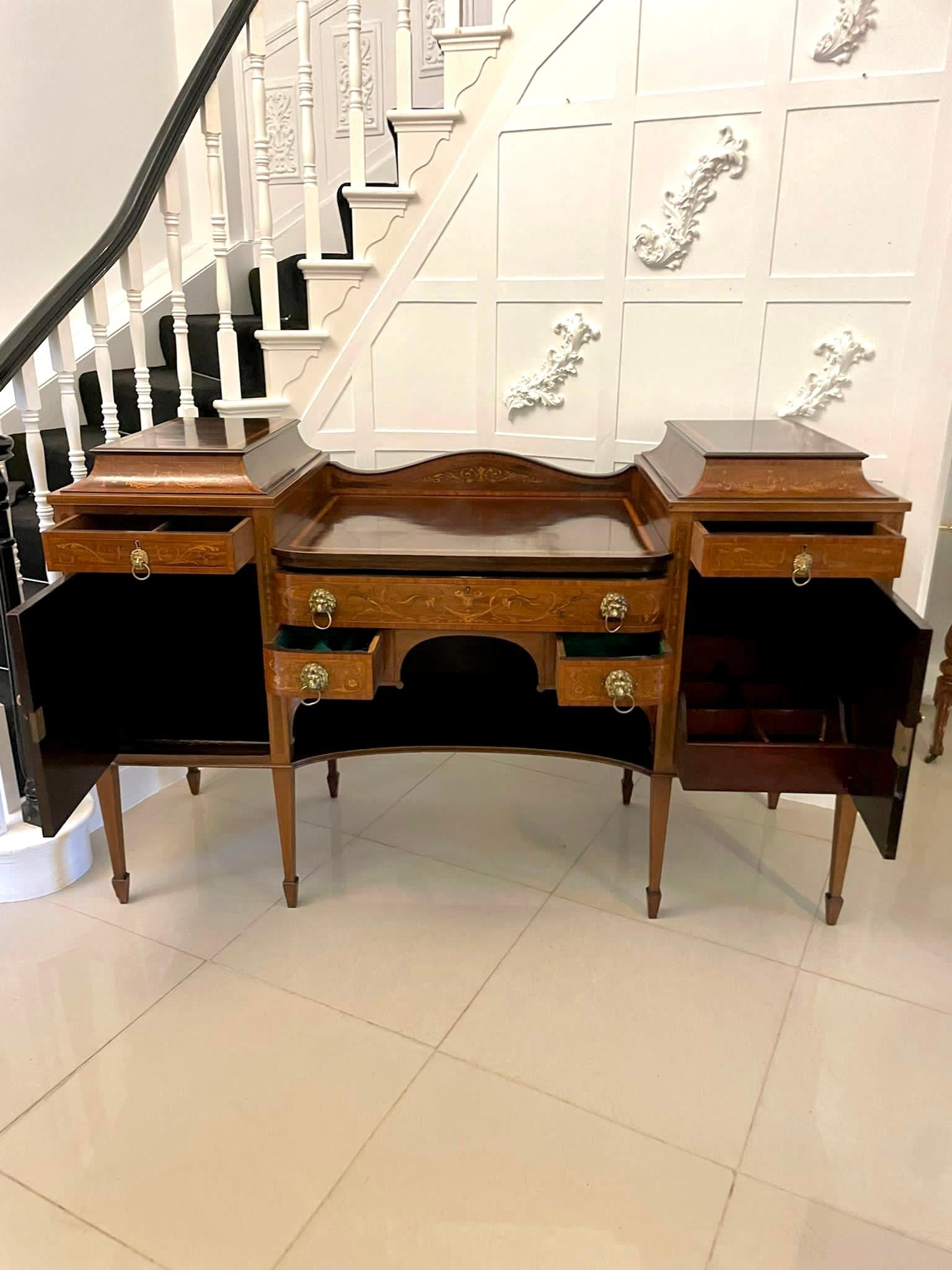 Fine quality antique 19th century mahogany inlaid marquetry sideboard by Hewetsons, London having a splendid shaped gallery back with satinwood inlay above twin pedestal cabinets with fantastic inlaid marquetry and floral motifs which open to reveal