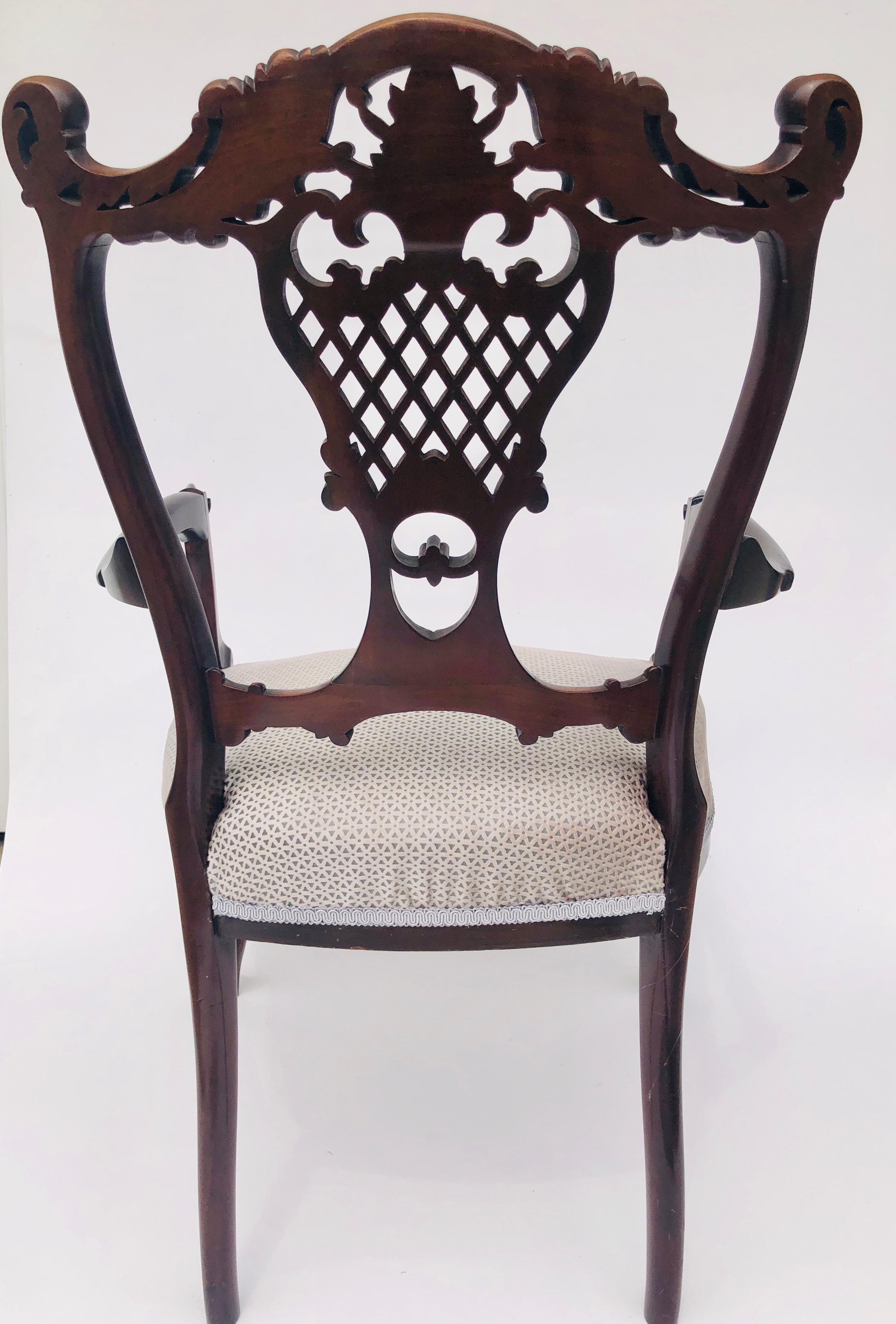 Fine quality antique 19th century Victorian mahogany carved armchair having a beautiful carved pierced shaped back. Shaped carved open arms, standing on carved cabriole feet and outswept back legs. Newly upholstered in a quality grey fabric.

A