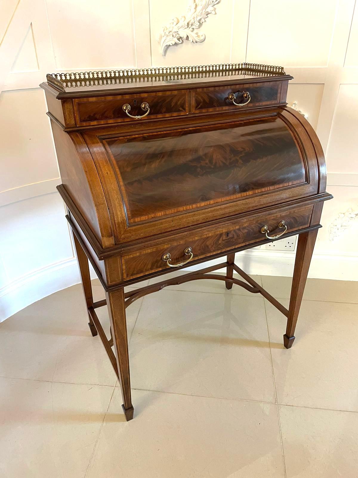 Fine quality antique Edwardian freestanding mahogany inlaid cylinder desk by Maple & Co. London having the original brass gallery above two mahogany drawers with pretty satinwood crossbanding and original brass handles above a cylinder top desk with