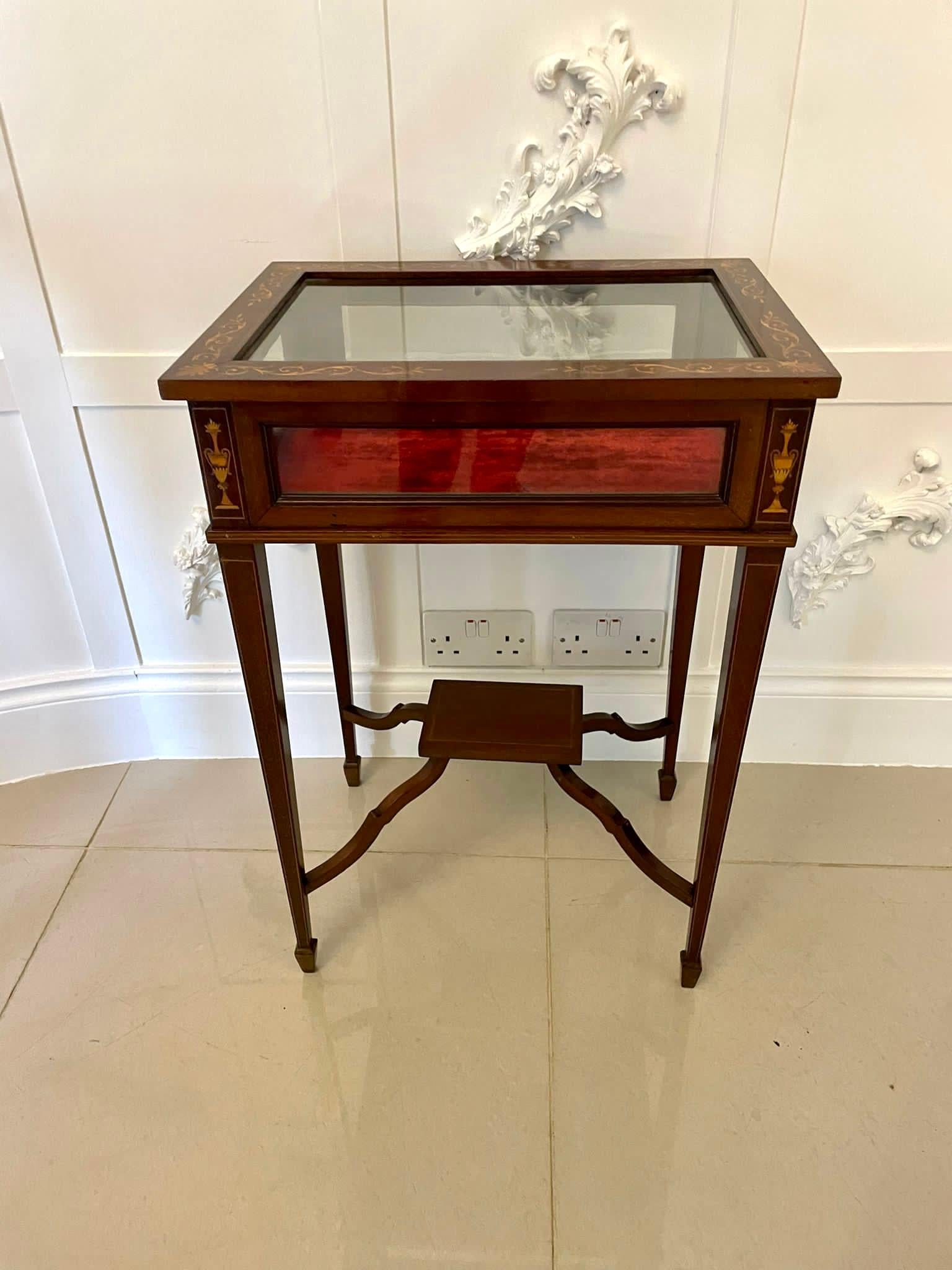 Fine quality antique Edwardian mahogany inlaid Bijouterie cabinet having a quality mahogany inlaid lift up top with a glazed inset above four glazed panels and inlaid satinwood urns. It stands on four mahogany square tapering legs with satinwood