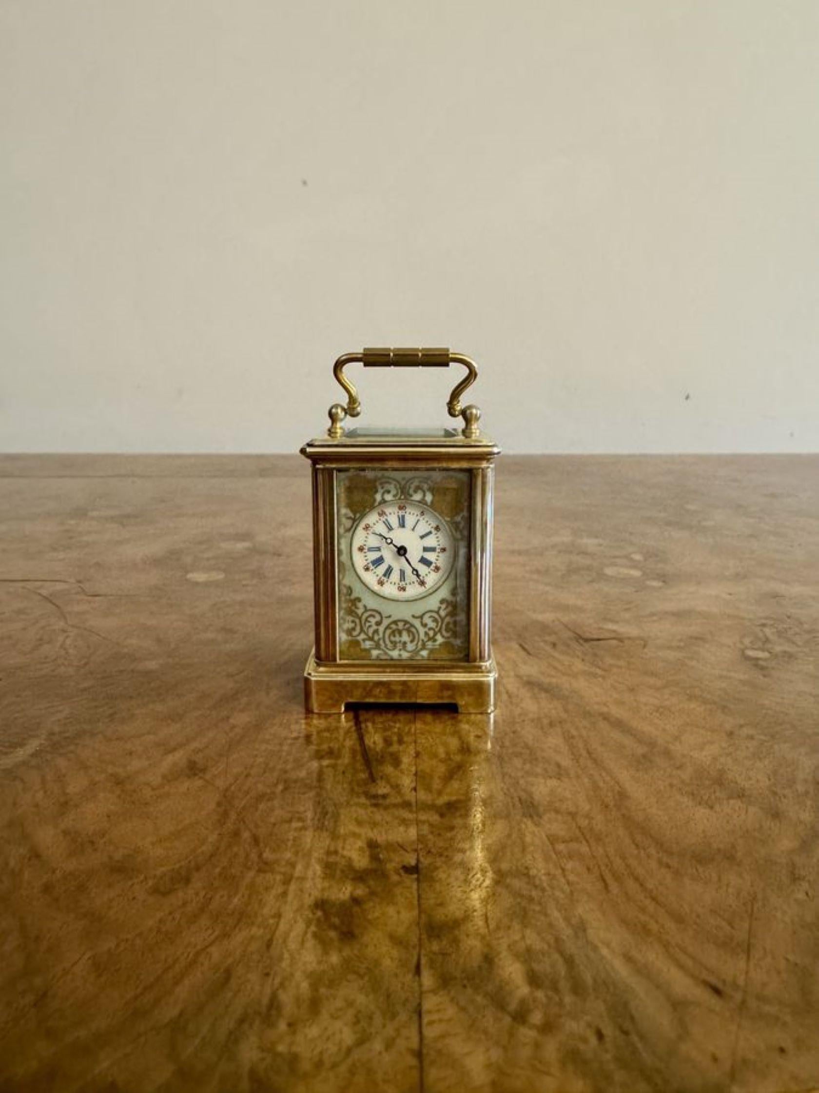 Fine quality antique Edwardian miniature carriage clock having a quality brass case with beautiful hand painted porcelain panels decorated with flowers and instruments in green, pink, blue and yellow colours surrounded by gold scrolls, having an 8