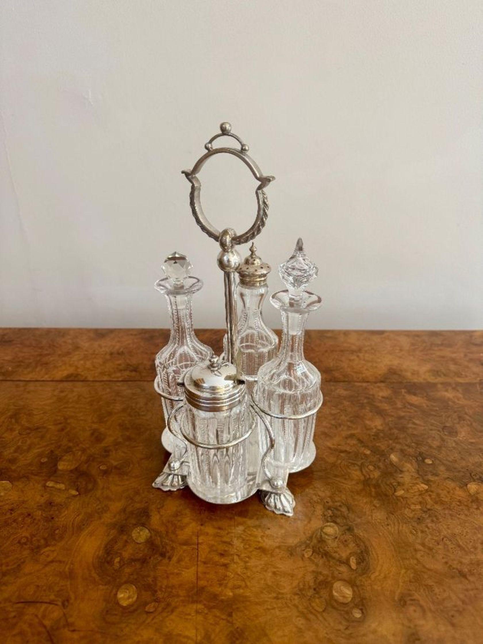 Fine quality antique Edwardian silver plated cruet set, having a quality silver plated stand with a shaped carrying handle to the middle, with four original cut glass bottles two with silver plated tops the other two with the original cut glass