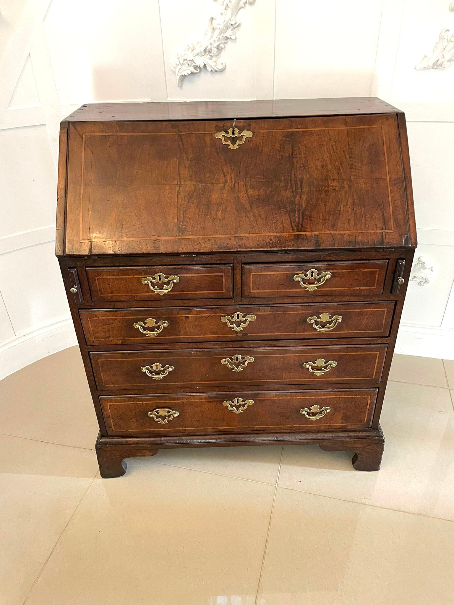 Fine quality antique George I figured walnut bureau with original handles having a fine quality figured walnut bureau with walnut inlay stringing, 2 short and 3 long oak lined drawers with original brass handles and escutcheons, fitted interior
