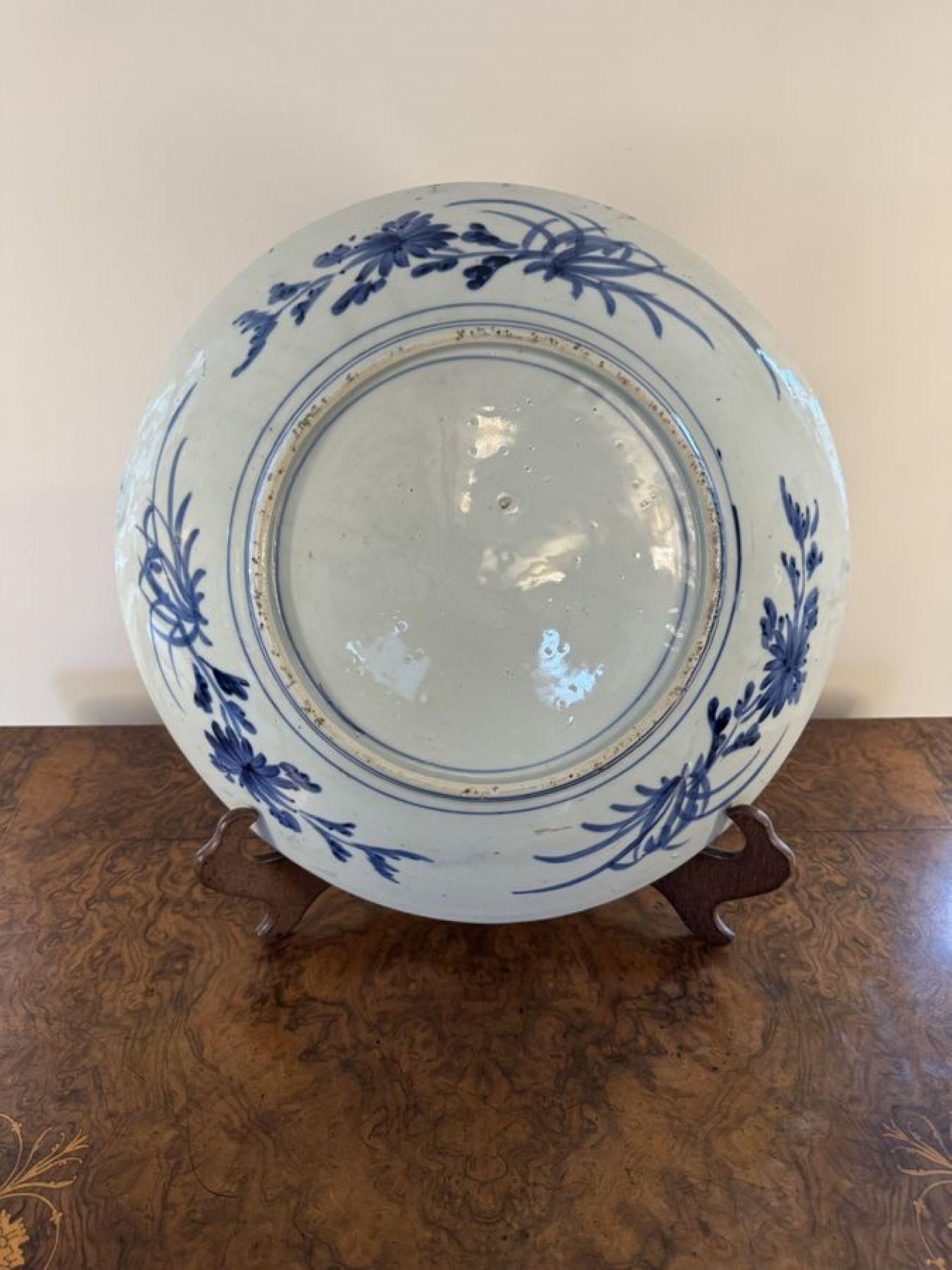 Fine quality antique Japanese blue and white imari charger, having a large Japanese blue and white imari charger decorated with blossoms surrounded by a patterned border in beautiful hand painted blue and white colours. 

D. 1900
