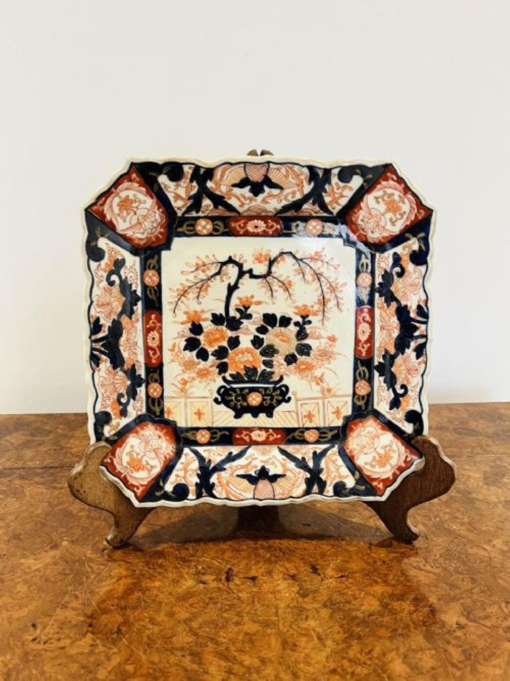 Fine quality antique Japanese imari large square plate having a shaped scalloped edge with quality hand painted panels depicting butterflies, flowers and scrolls, to the centre having a vase of flowers, leaves and a tree in wonderful red, blue,