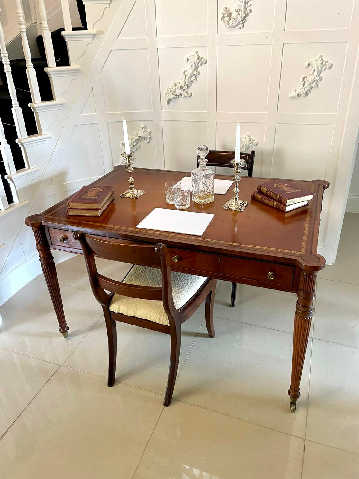 Fine quality antique mahogany partners writing table/desk having a delightful crossbanded top with original tan leather writing surface, two cockbeeded drawers either side with original brass knobs standing on elegant reeded tapering legs with