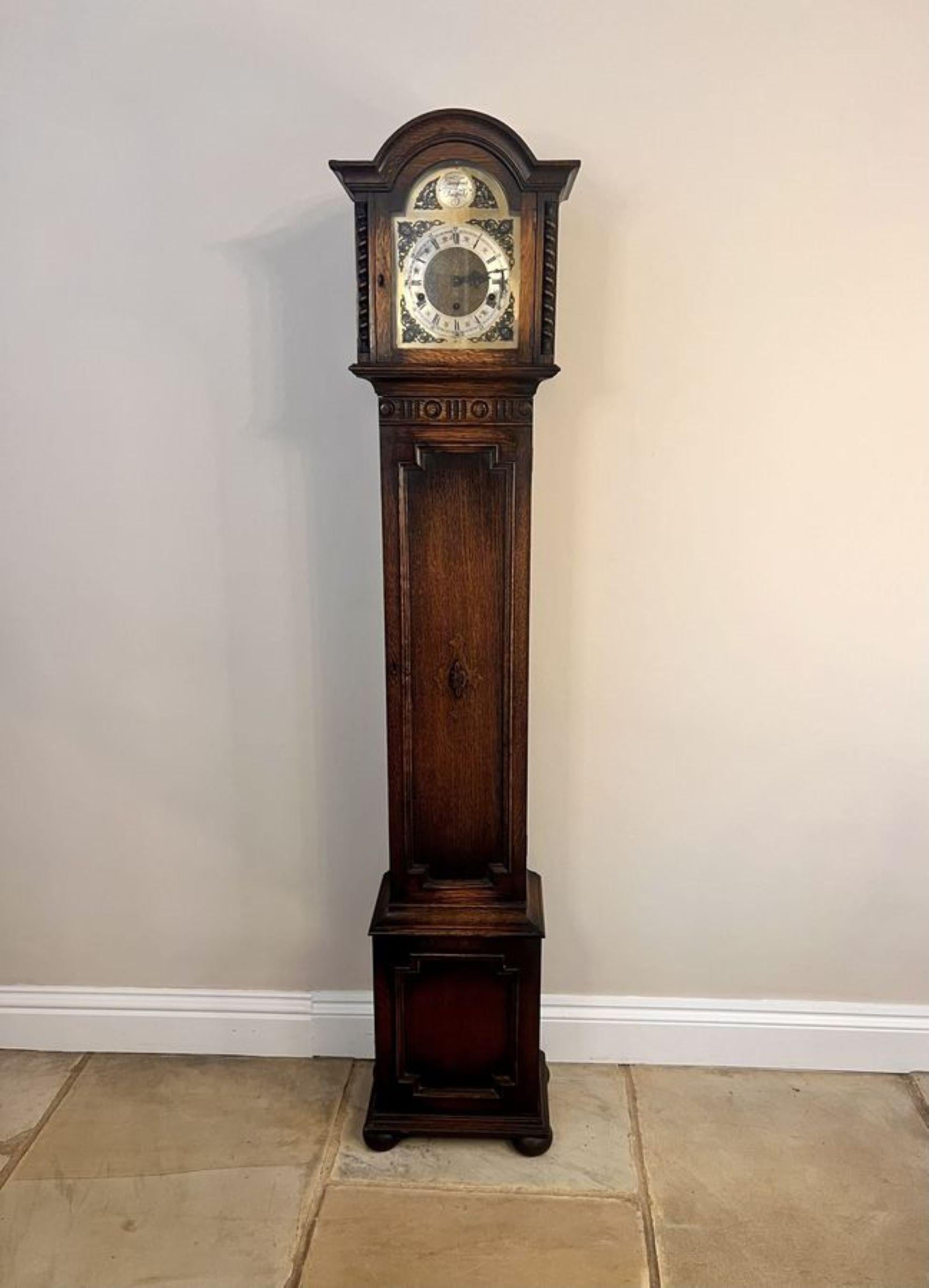 Fine Quality Antique Oak 8 Day Chiming Grandmother Clock having a quality oak case with carved mouldings and fine barley twist columns, with an ornate dial and a arched brass face with ornate spandrels and inscribed 'Tempus Fugit' with the original