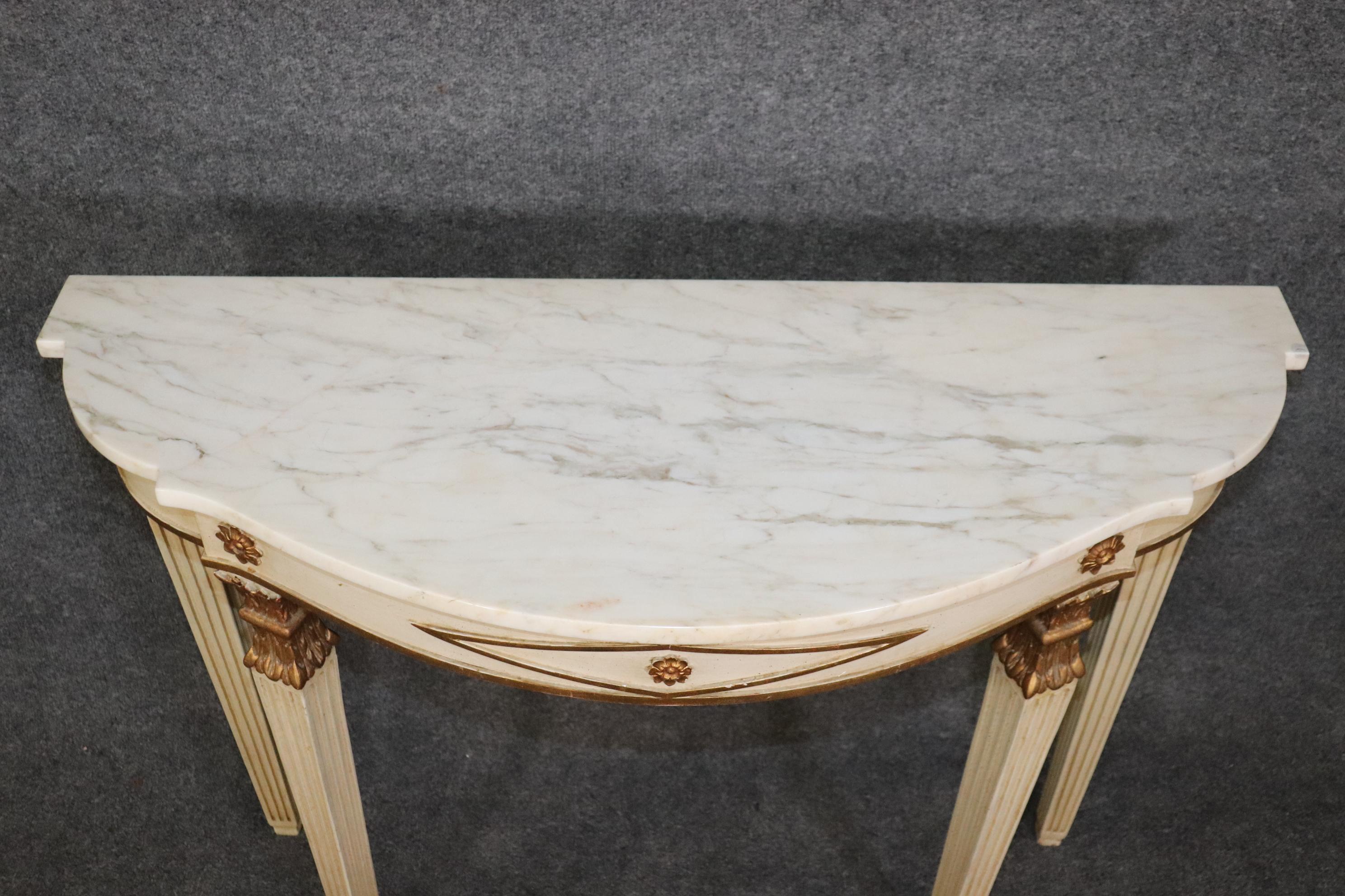 This is a gorgeous antique paint Decorated and gilded marble top console table in the Directoire style. The table is in good condition with no issues to speak of and measures 42.5 wide x 33.25 tall x 15.5 deep. The table has a nice marble top and