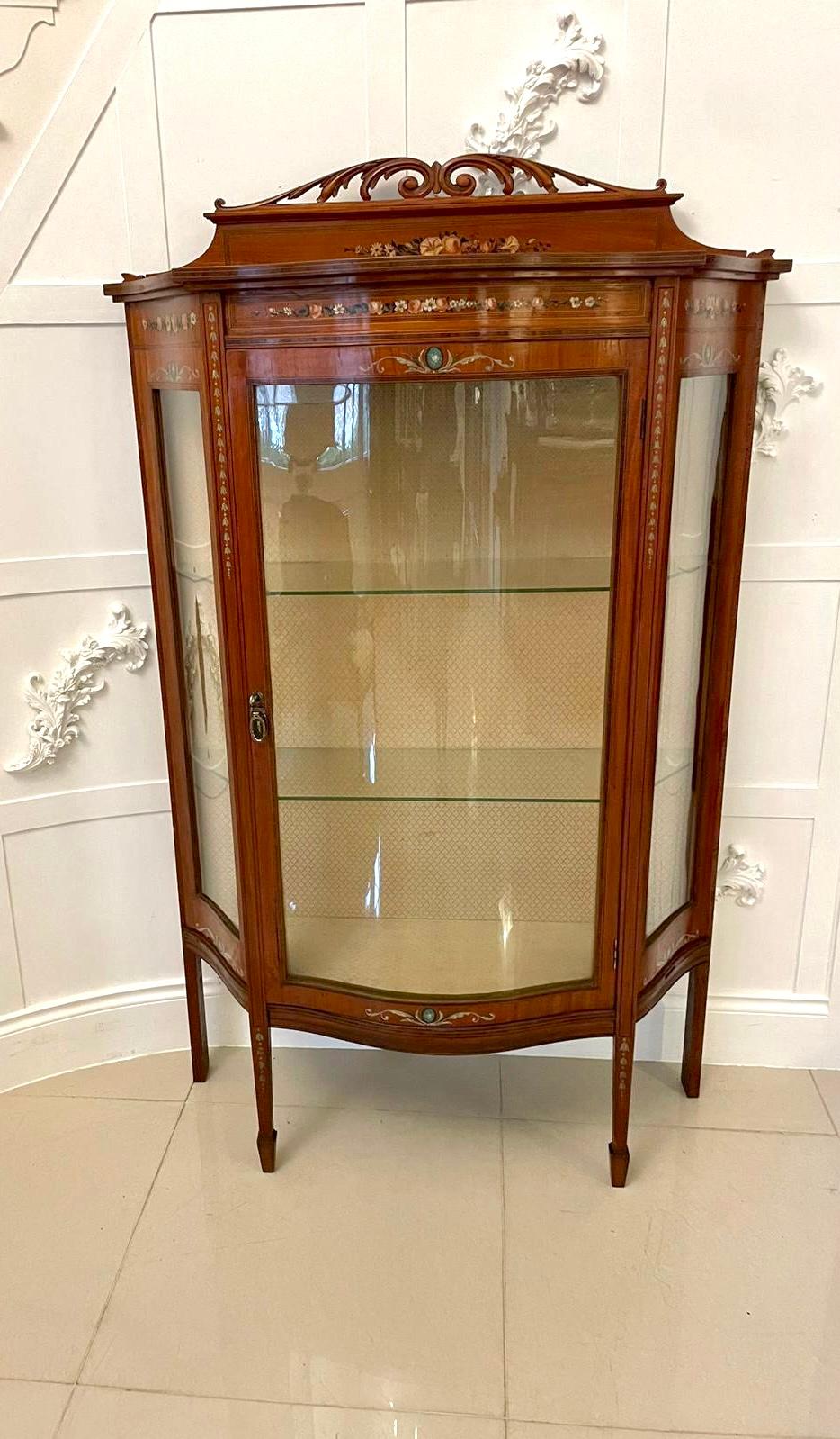 Fine quality antique Victorian satinwood display cabinet with original beautiful painted decoration having a fine quality antique Victorian serpentine shaped satinwood display cabinet with a hand painted and carved gallery top above a serpentine