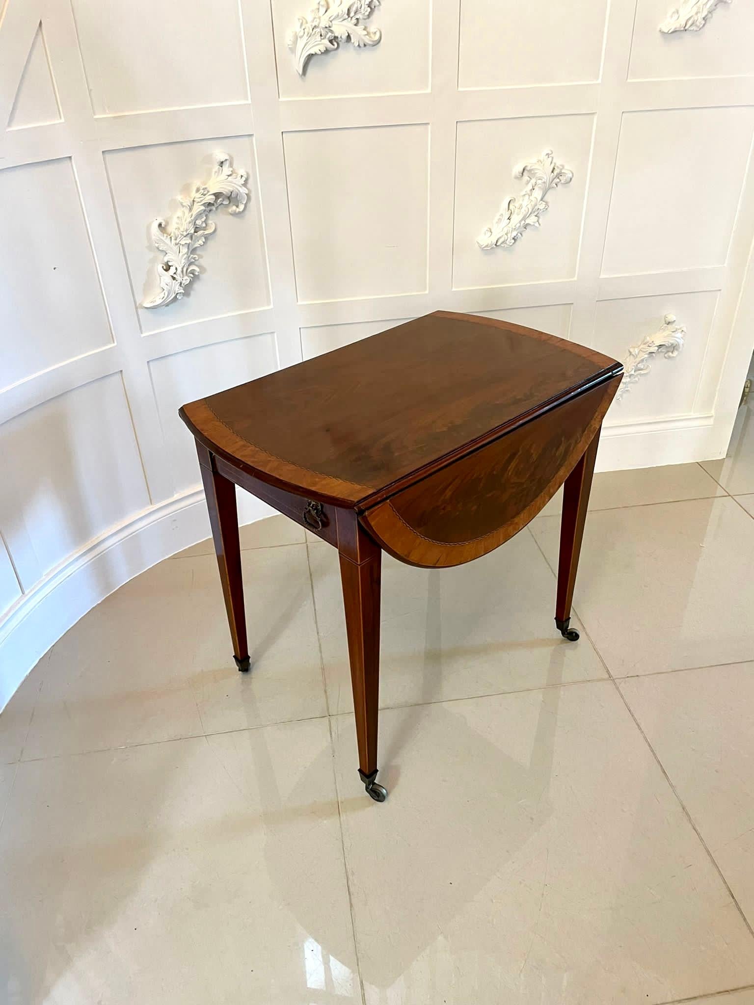 Fine quality Antique Sheraton period inlaid mahogany pembroke table having a quality mahogany top beautifully crossbanded in satinwood, two oval drop leaves, one drawer and one dummy drawer to the frieze with original brass handles. It stands on