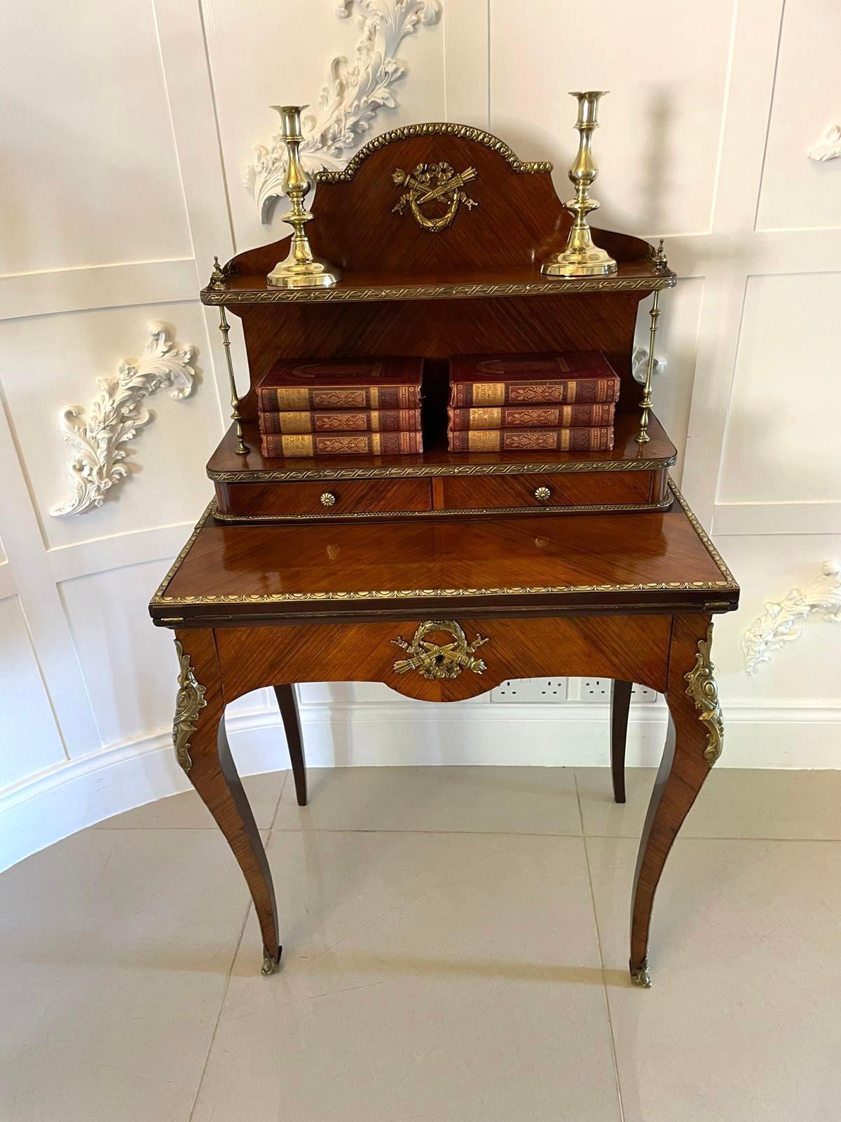 Fine quality antique Victorian French kingwood bonheur du jour having a quality shaped gallery top with ornate ormolu mounts, two brass columns supports, two drawers and a shelf above a fold over writing surface supported by a frieze drawer with an