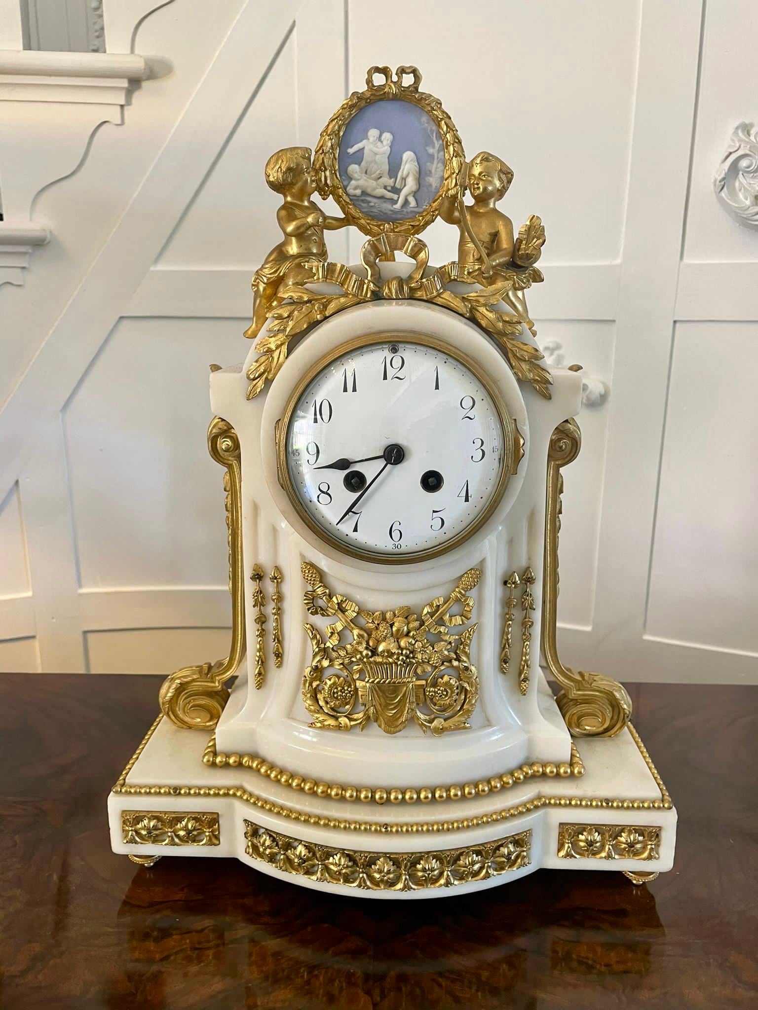 Fine quality antique Victorian French marble and ormolu mounted clock set having a fine quality French clock set in cream marble with outstanding quality ormolu mounts and a glorious Wedgwood plaque flanked by a pair of pretty cherubs,  circular
