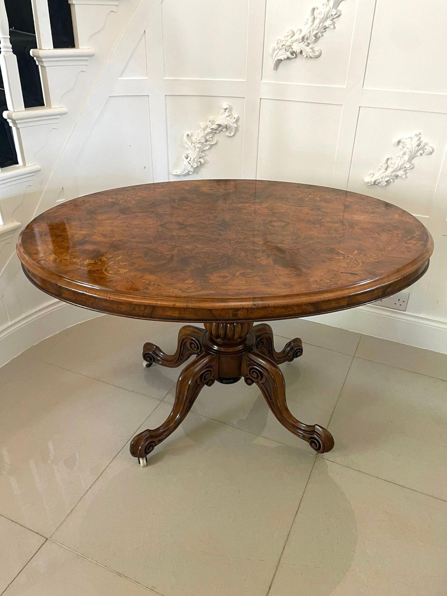 Fine quality antique Victorian oval inlaid burr walnut centre table having a fine quality attractive burr walnut oval tilt top table with pretty satinwood inlay and a thumb moulded edge supported on a shaped turned carved pedestal column standing on