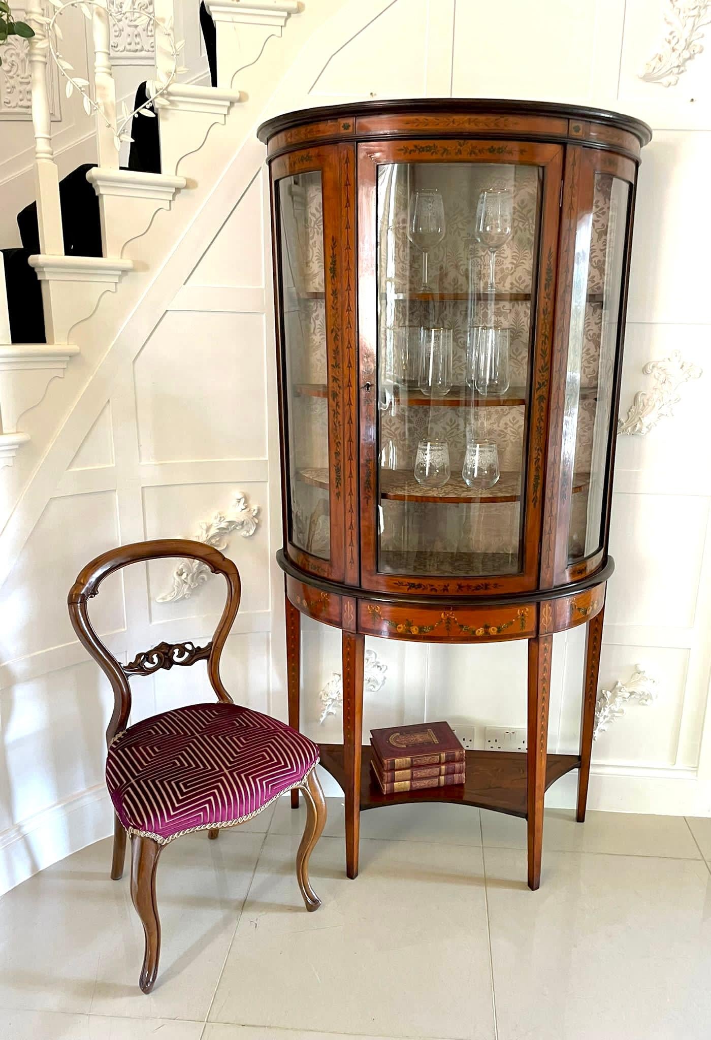 Fine quality antique Victorian satinwood demi-lune shaped display cabinet with original beautiful hand painted decoration, single glass door to the centre opening to reveal three adjustable shelves flanked by glazed sides above a pretty satinwood