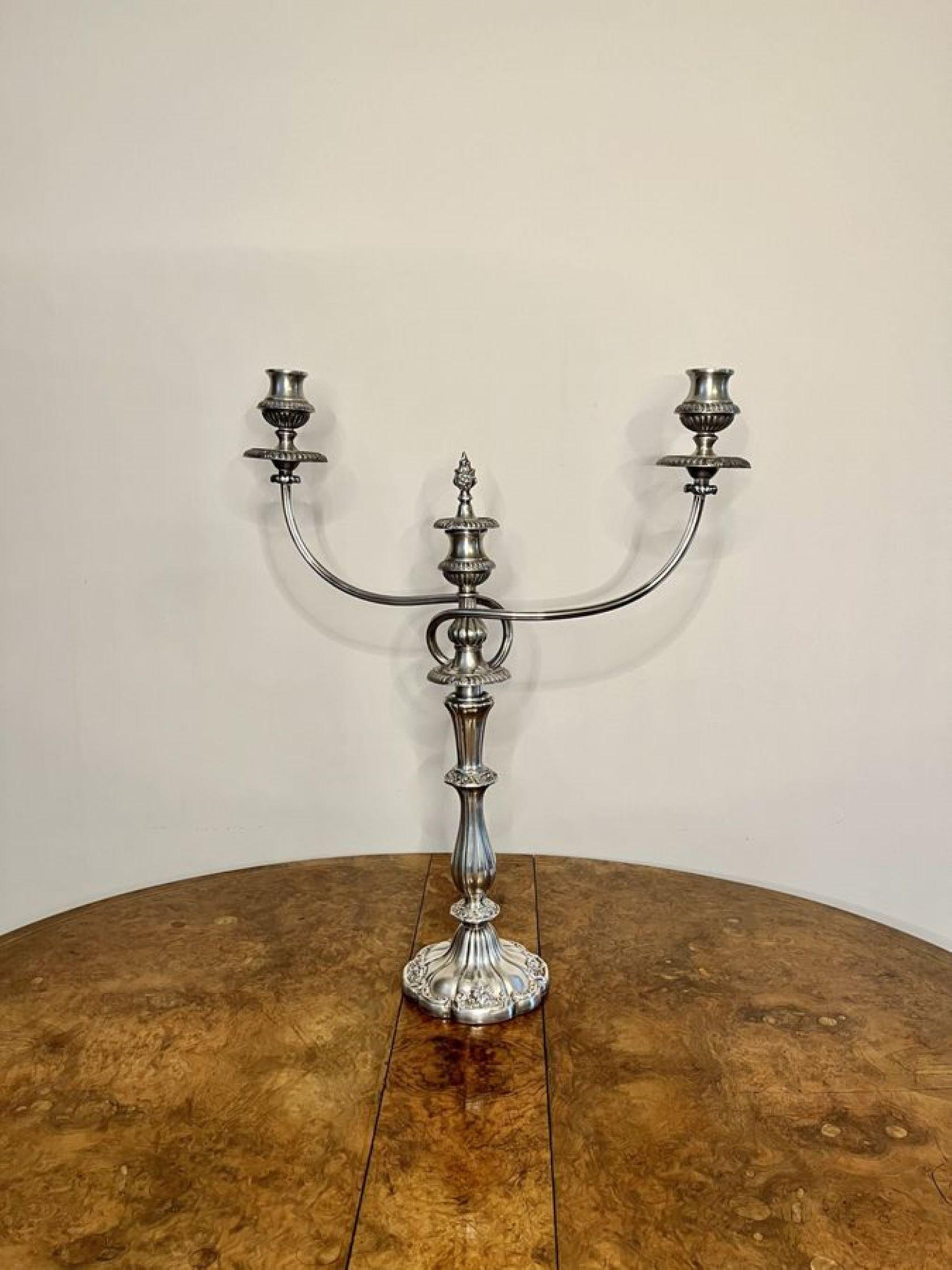 Fine quality antique Victorian silver plated candelabra having a quality ornate base and a shaped reeded column with a two branch candelabra with a center candle holder with a removable ornate finale.

D. 1880