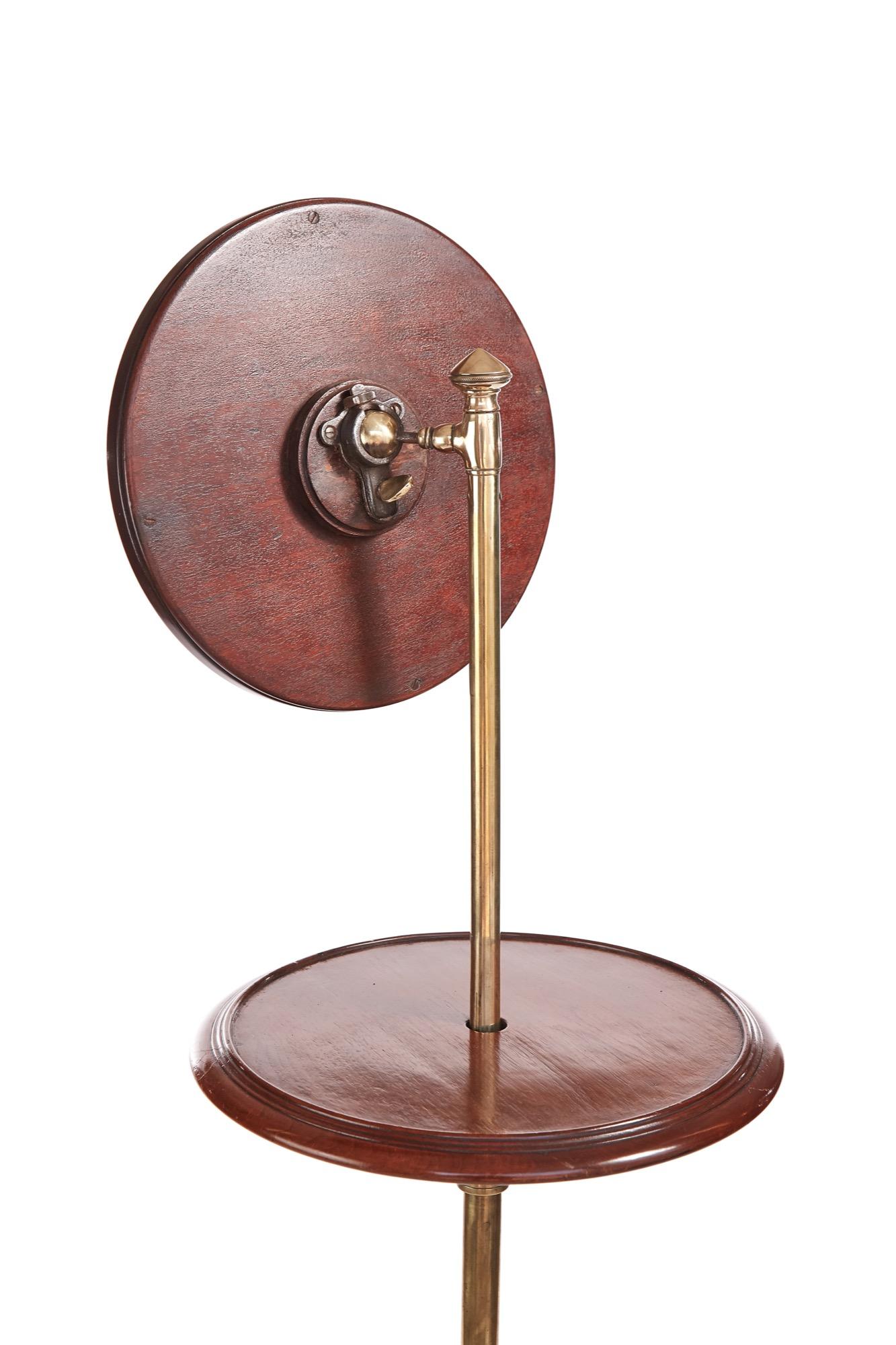 Fine quality antique Victorian telescopic shaving stand having an adjustable fine carved mahogany framed mirror. Fine quality carved mahogany circular table top supported by original brass adjustable telescopic pole raised on a fine quality twisted