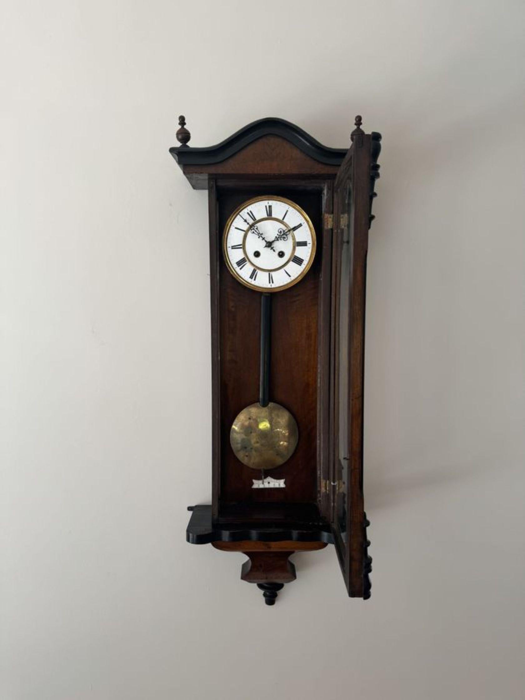 Fine quality antique Victorian walnut cased Vienna wall clock, having a single walnut glazed door opening to reveal a circular porcelain dial with Roman Numerals and the original hands, having an eight day movement striking the hour and half hour on