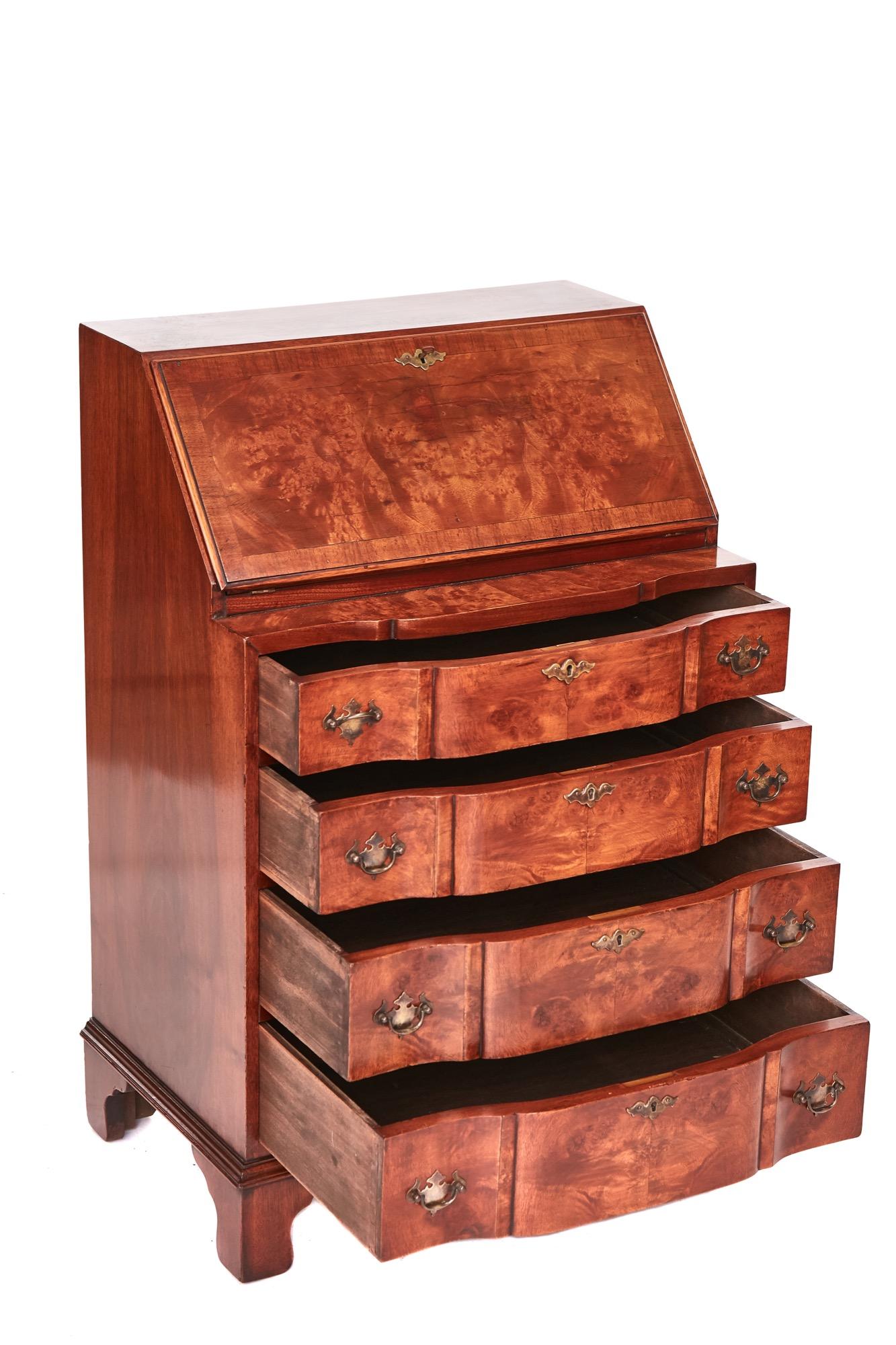 Fine quality antique walnut bureau having a beautiful walnut cross-banded top with a fall opening to reveal a fully fitted interior consisting of four shaped drawers, shaped pigeon holes and shaped shelves, four shaped drawers to the front and