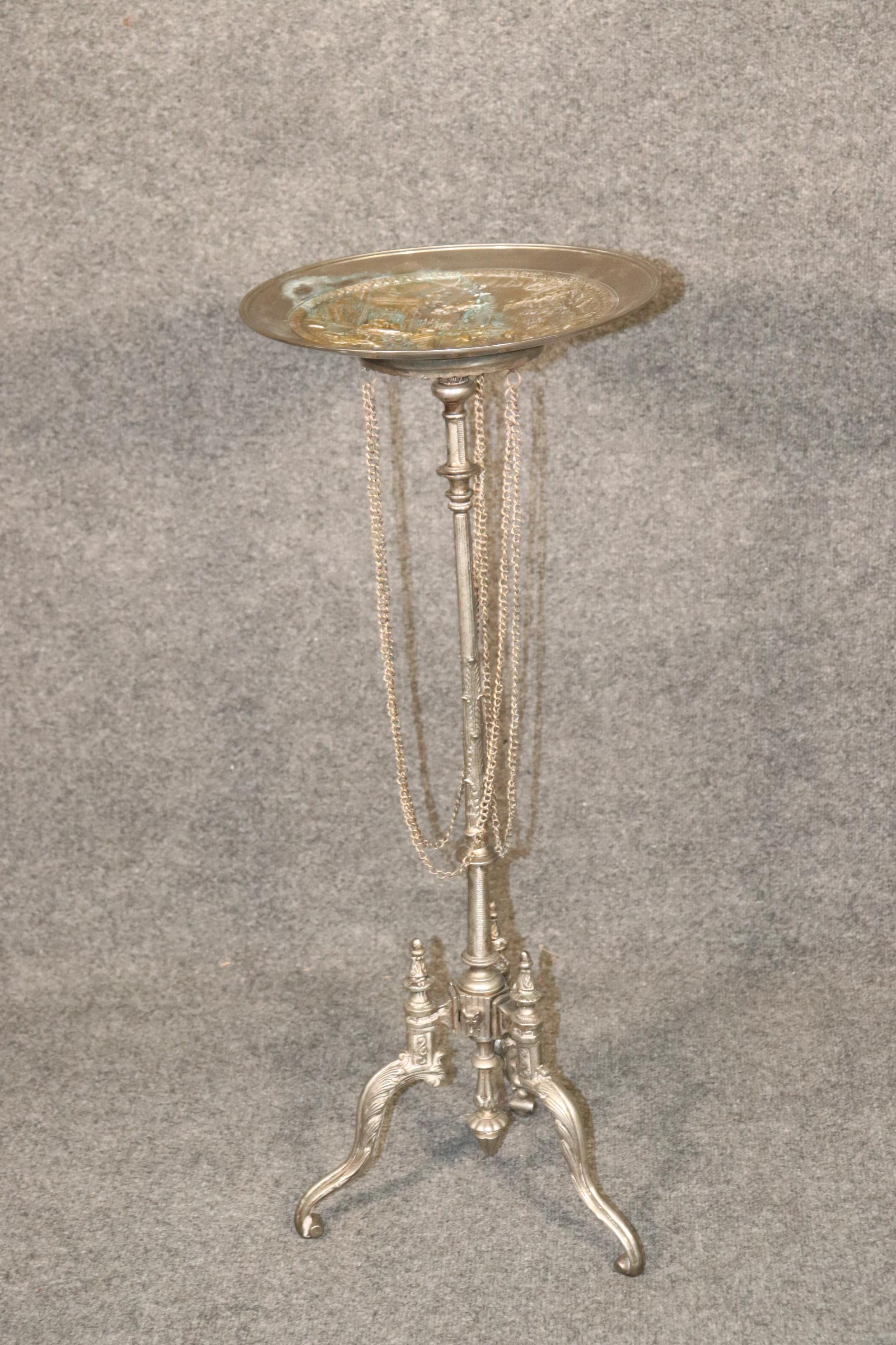 Dimensions- H: 32in W: 13in D: 13in 
This is a stunning calling card table. This was originally used for placing calling cards at parties. The top is embossed heavy brass or polished bronze and depicts an elaborate Greek mythological scene with