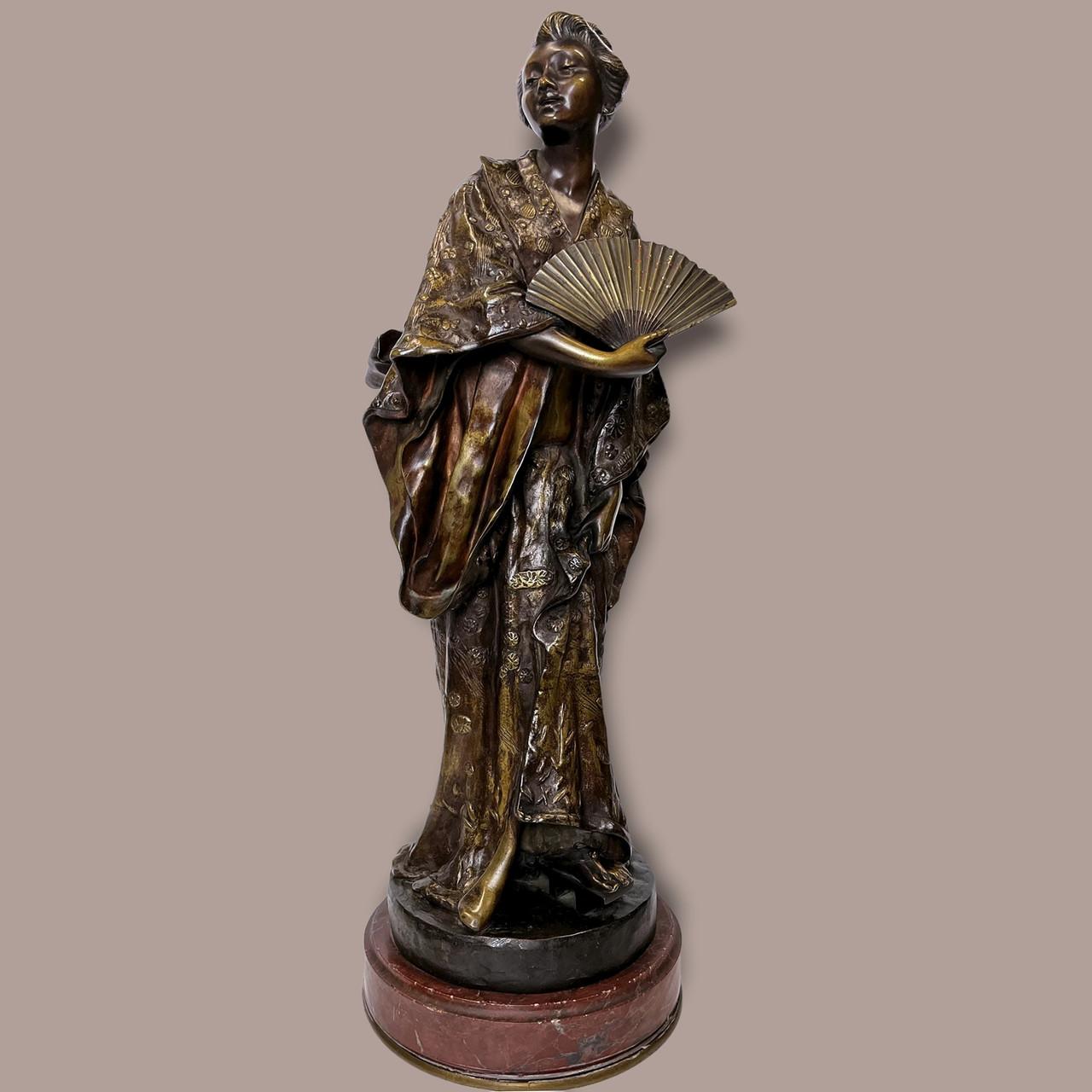Patinated Bronze Statue of Japanese Geisha wearing Beautiful Kimono by G. Leroux.

This female figural bronze of a Japanese woman wearing an exquisite Kimono and holding a fan showcases brilliant drapery and intricate fabric designs. Her Kimono,