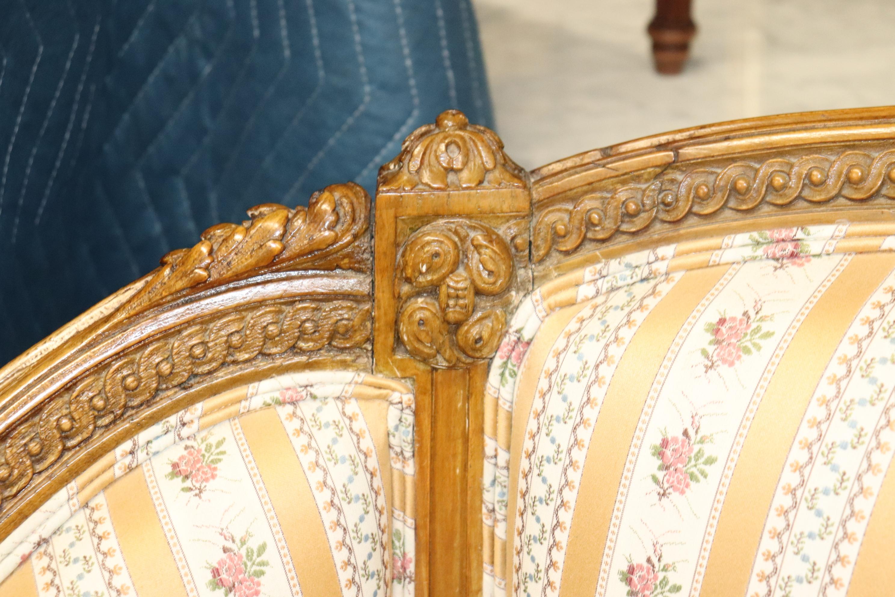 The carving is what this settee is all about! Look at the crispness of the carving and the finish. Notice the proportions and design. This is a superb French sofa in good original condition. The settee measures 64 wide x 42 tall x 27 deep and the