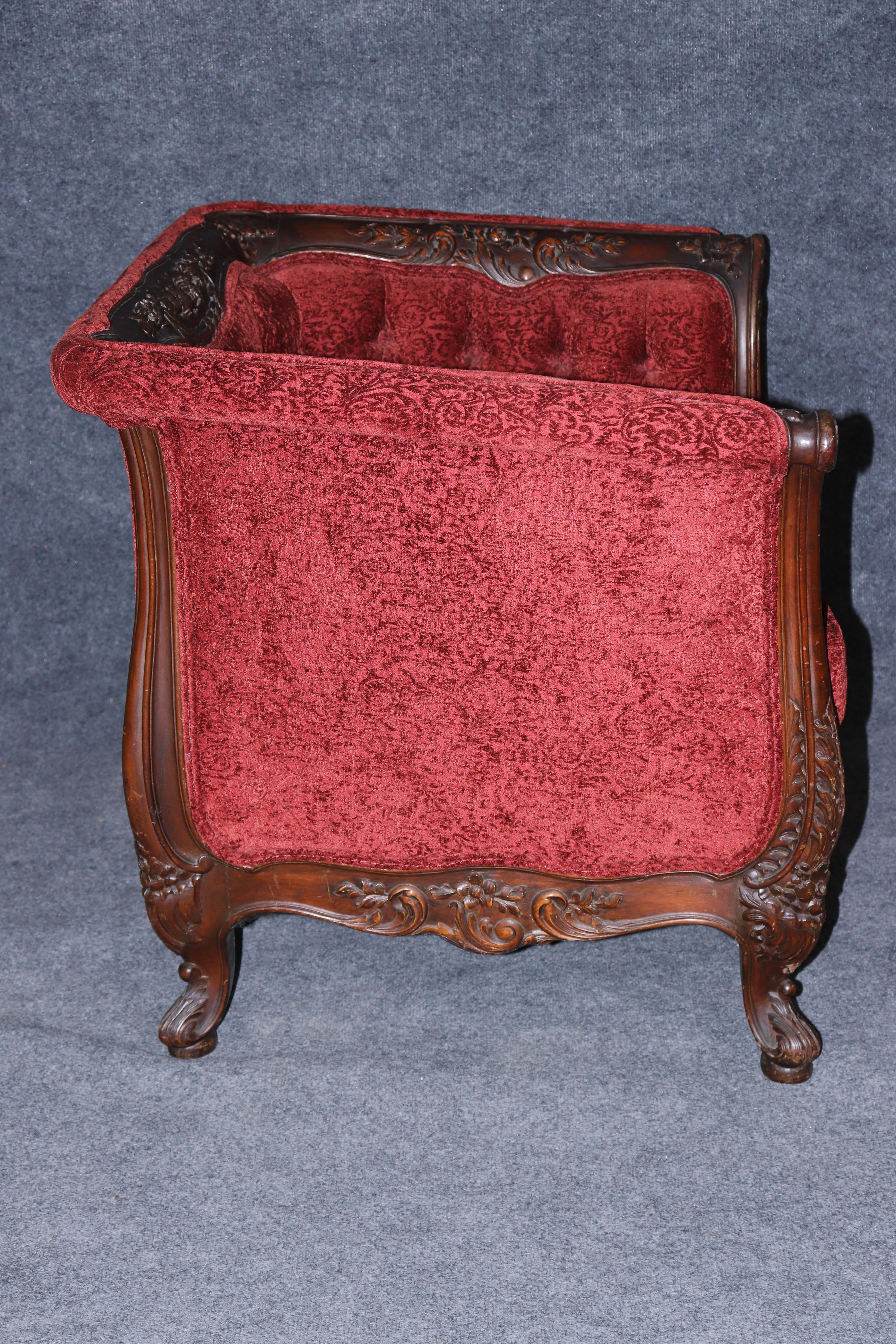 This is a part of a two-piece set with a sofa listed separately. The chair is extremely well carved and in good condition with older red upholstery and the frame being an eve-arm frame makes it very comfortable to sit in. It's almost like a club