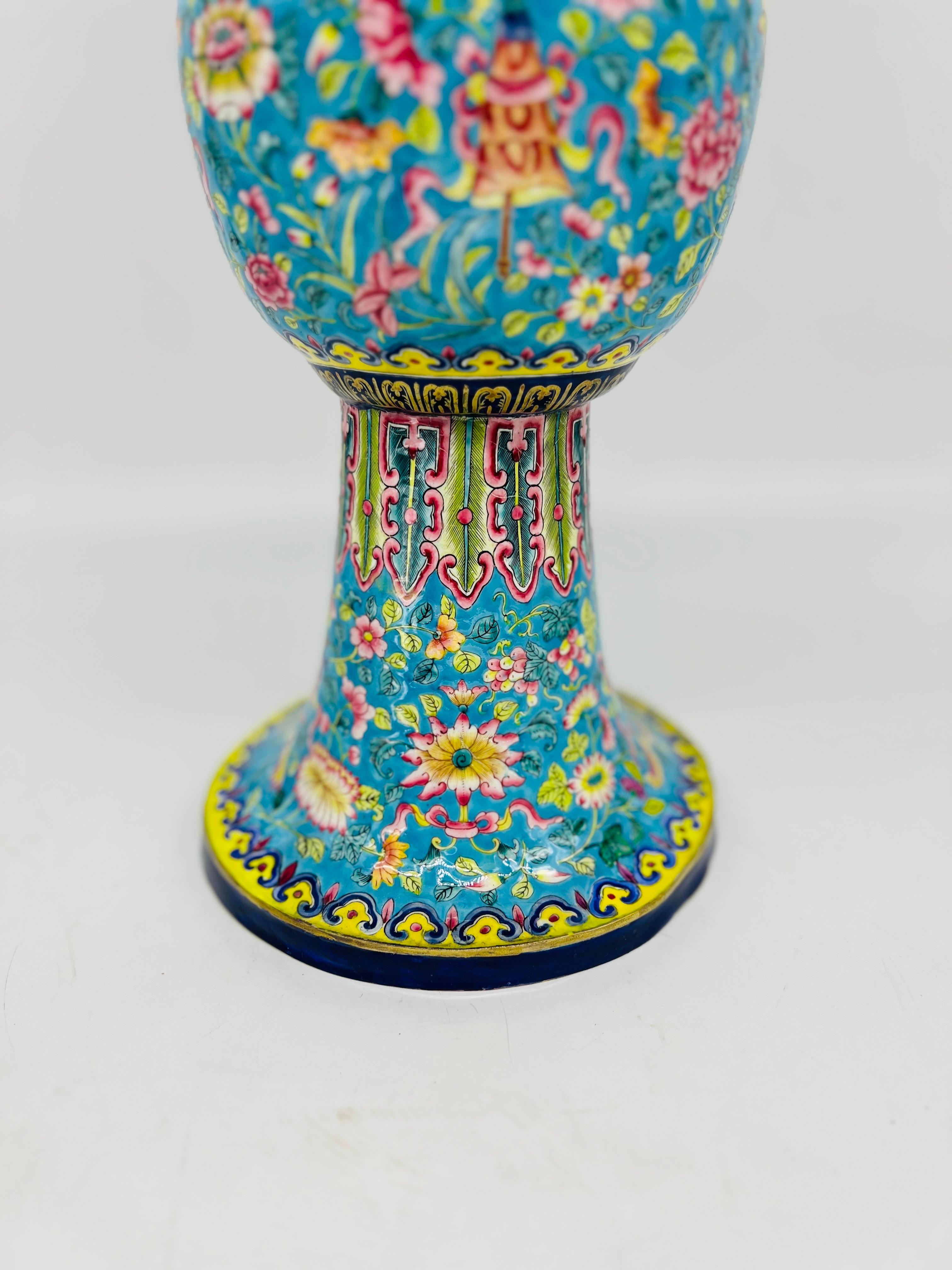 The Fine Quality Chinese Export Enamel on Copper Gu Form Vase is a stunning example of traditional Chinese craftsmanship. This vase is made from copper, which serves as the base material, and is adorned with exquisite enamel work. 

The gu form,