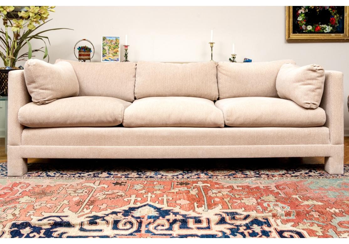 A fine quality custom parson's or tuxedo style upholstered sofa in the manner  of Milo Baughman. The sofa with covered square legs and two tapering center support legs. The sofa with three loose cushions, back seat cushions and side bolster