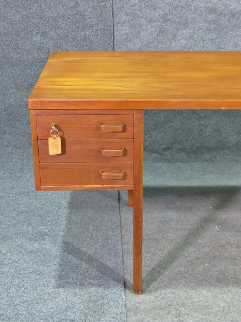 This is a gorgeous teak desk made in Denmark. The desk features 6 dovetailed drawers and measures 27 3/8