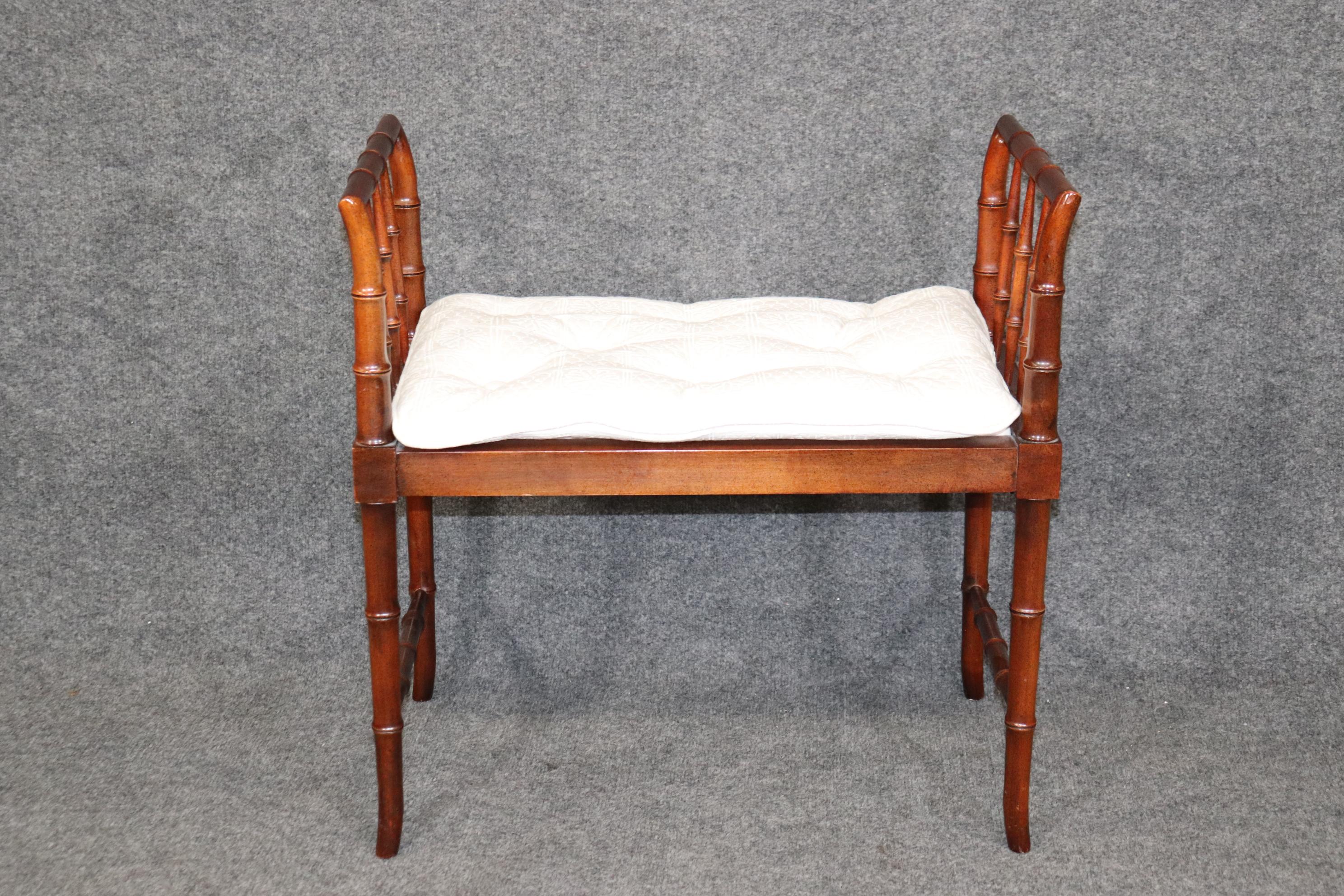 This is a beautifully made Baker French faux bamboo stool or bench. The bench is in good condition and has minor signs of age and wear but nothing significant. The upholstery is not new so it may have some minor stains or issues. The bench measures
