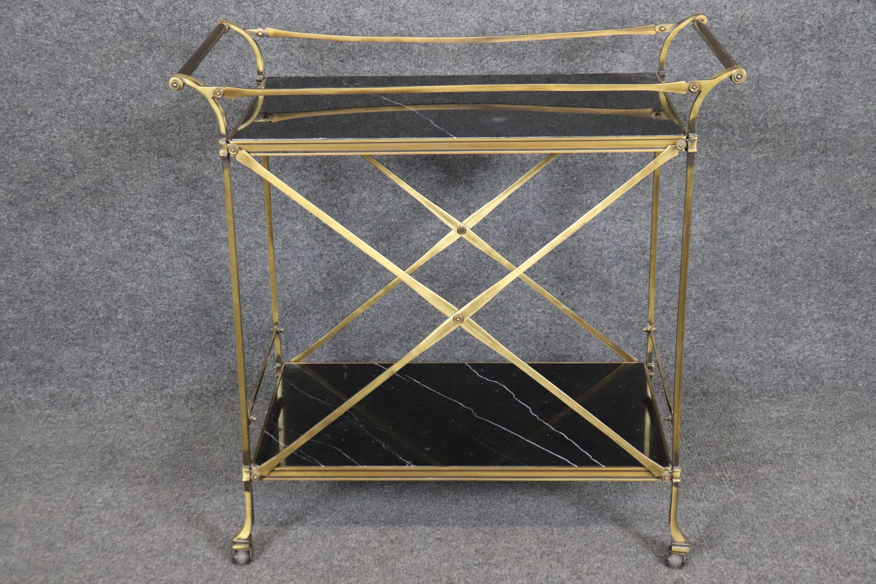 This is a superb hand-forged brass and black and white marble two tier bar or liquor cart. of course you can use it for pastries or wine. The piece is in very good condition and has no major issues to mention beyond minor signs of use. Measures 32