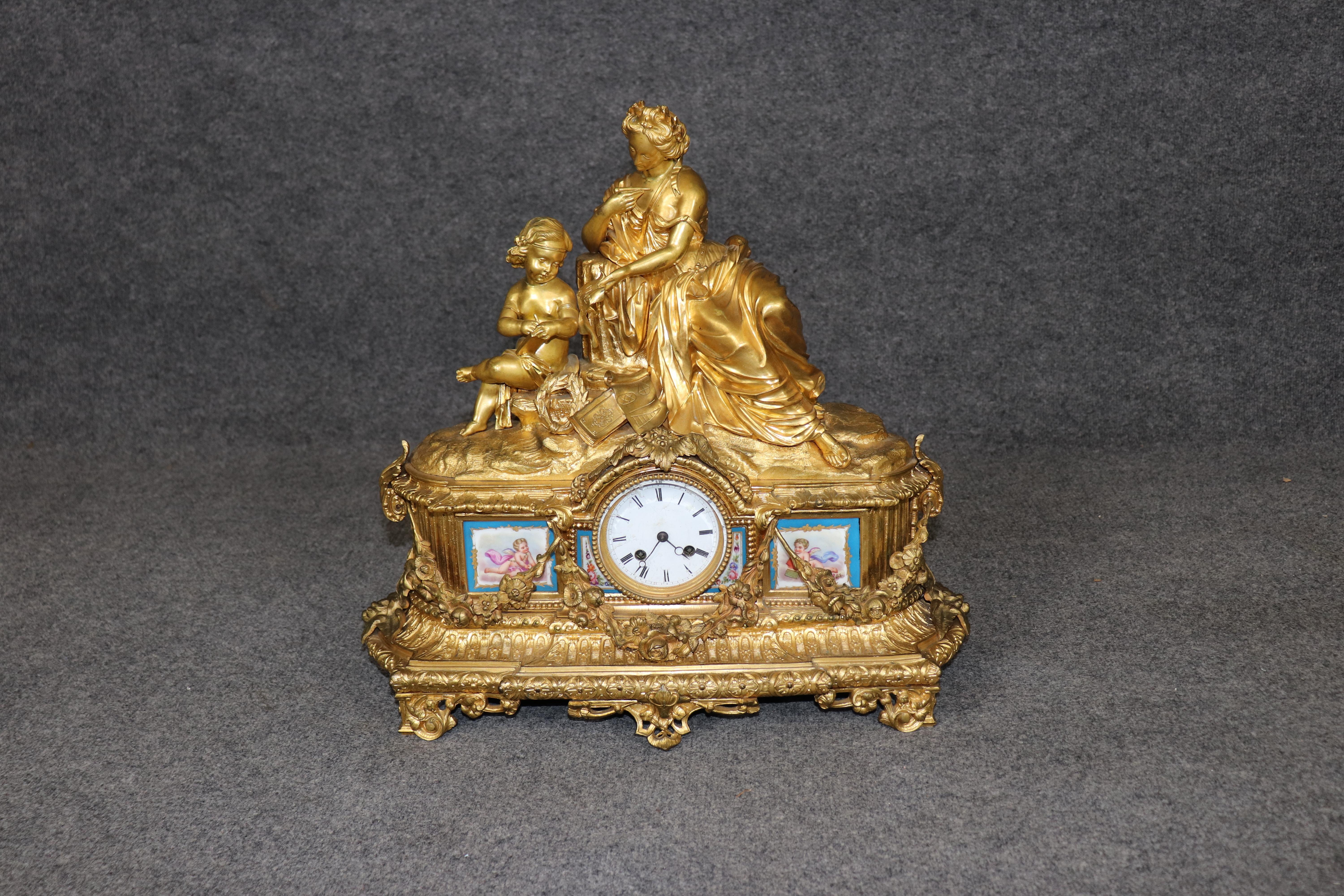 This is a superb gold dore' bronze figural French made Louis XV style clock with Sevres plaques. The clock is absolutely breathtaking and would make a fantastic focal point in the right room or mantel. The clock dates to the 1920-30s era and is