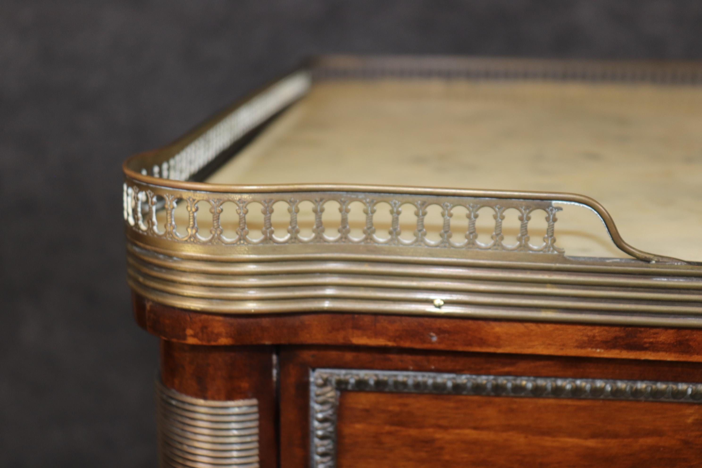 This is a superb Maison Jansen style bronze mounted commode. The commode has all of the tell-tale elements of a Jansen commode but isn't signed. The quality is there. The bronze and brass make sense. The design and articulation of proportion and